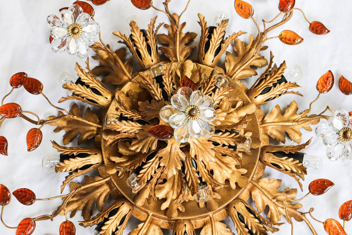 Introducing this large gilt iron and crystal flush mount Maison Baguès ceiling light adorned with 15 lights, Crystal Flowers and dark Amber coloured Leaves. France 1940s.

Exquisite in every detail, this ceiling light showcases gilded metal