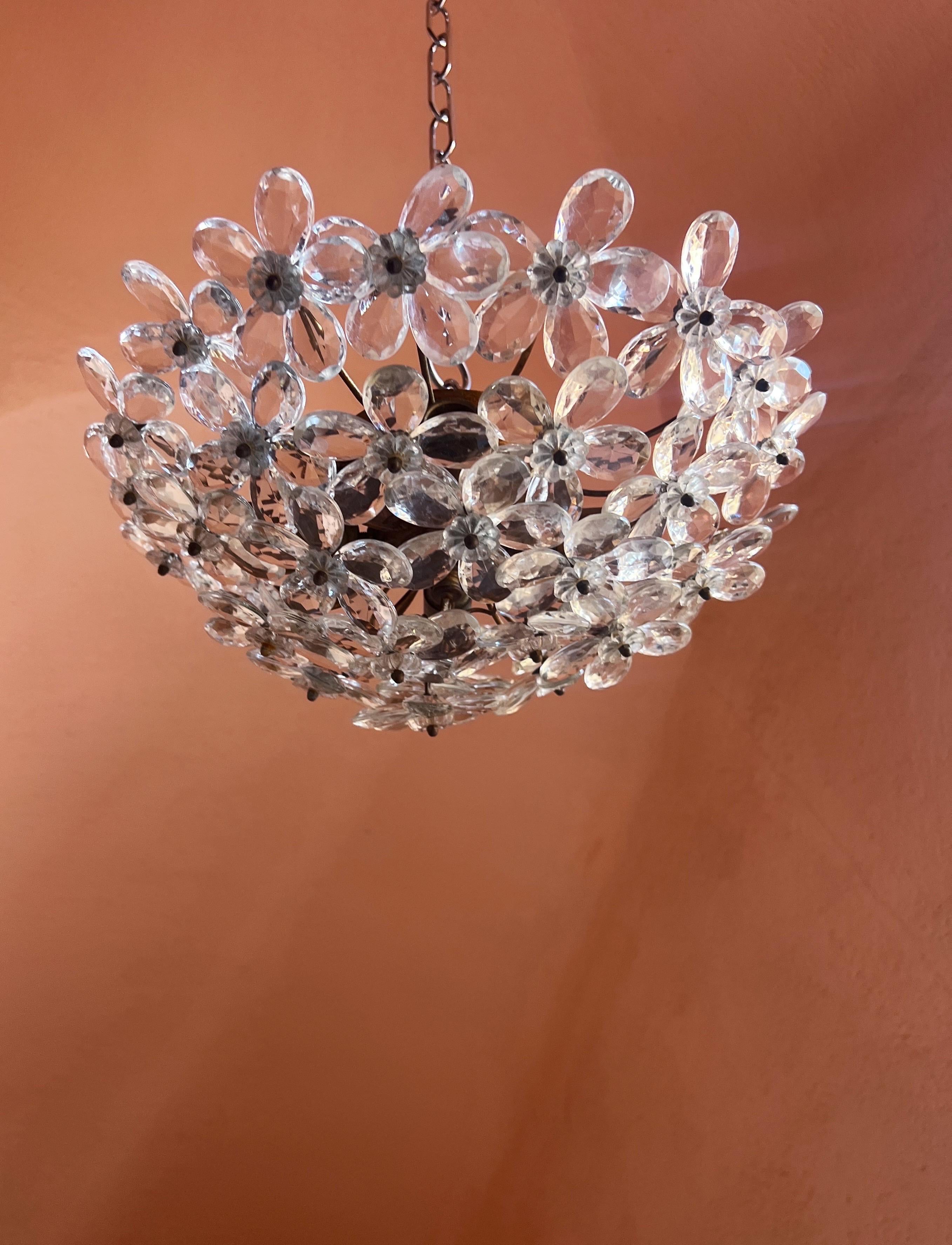 A beautiful flush mount light featuring delicate clear Murano glass flowers arranged on a metal base. The fixture itself is French, crafted by the renowned Maison Baguès, known for their refined and timeless lighting designs.

The clear glass