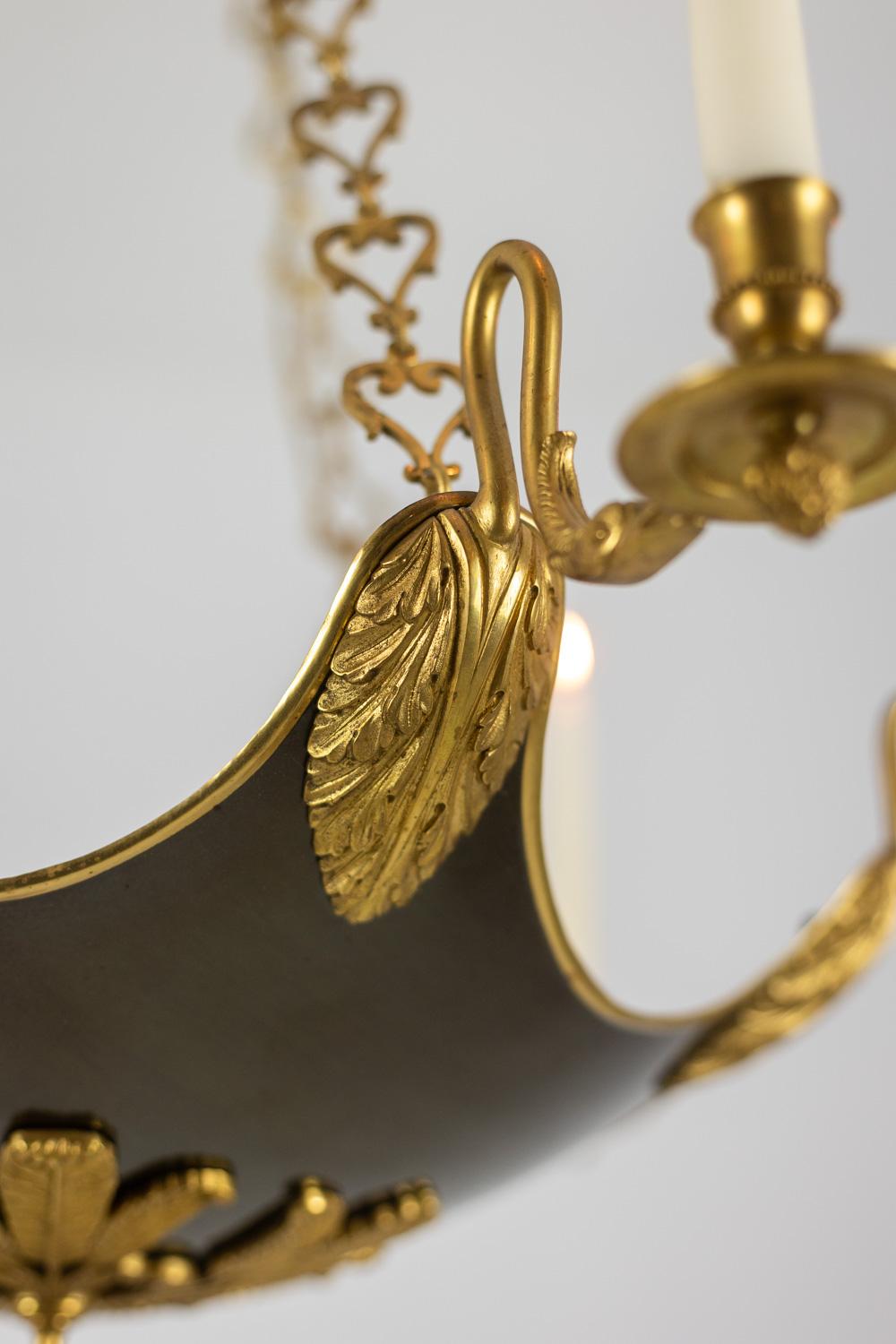 Maison Baguès, by.

Empire or Restoration style chandelier in gilded bronze and black lacquered sheet metal, with six arms of light, allowing the placement of six candles, decorated with swans’ necks, whose bobeches end with stylized tassels and are