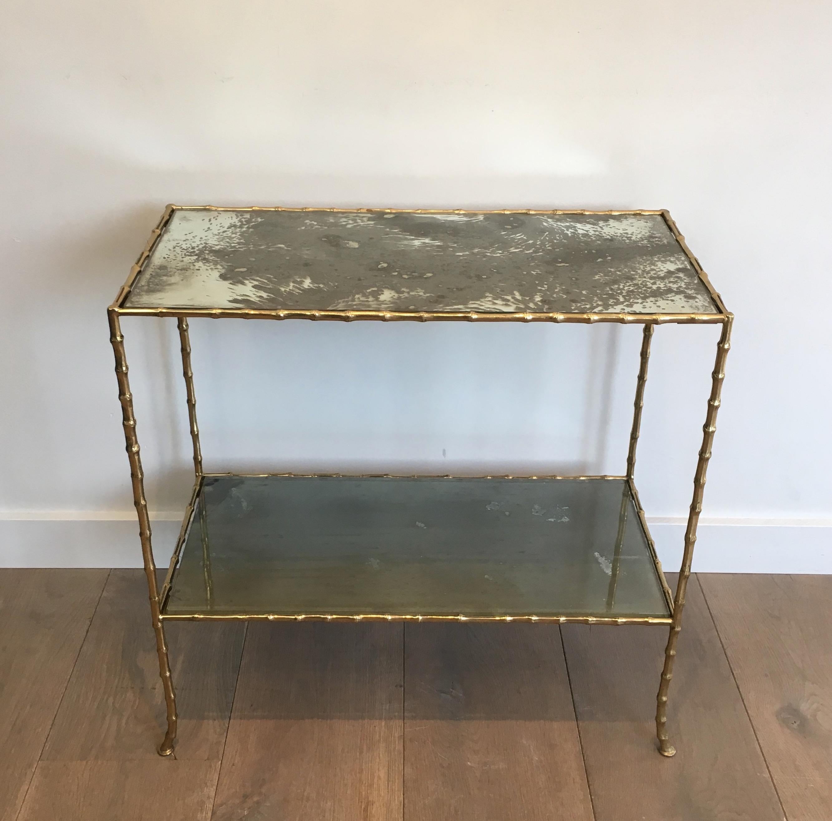 This beautiful faux-bamboo side table is all made of bronze with very nice original oxydized glass shelves. This is a work by famous French designer Maison Baguès. Circa 1940.