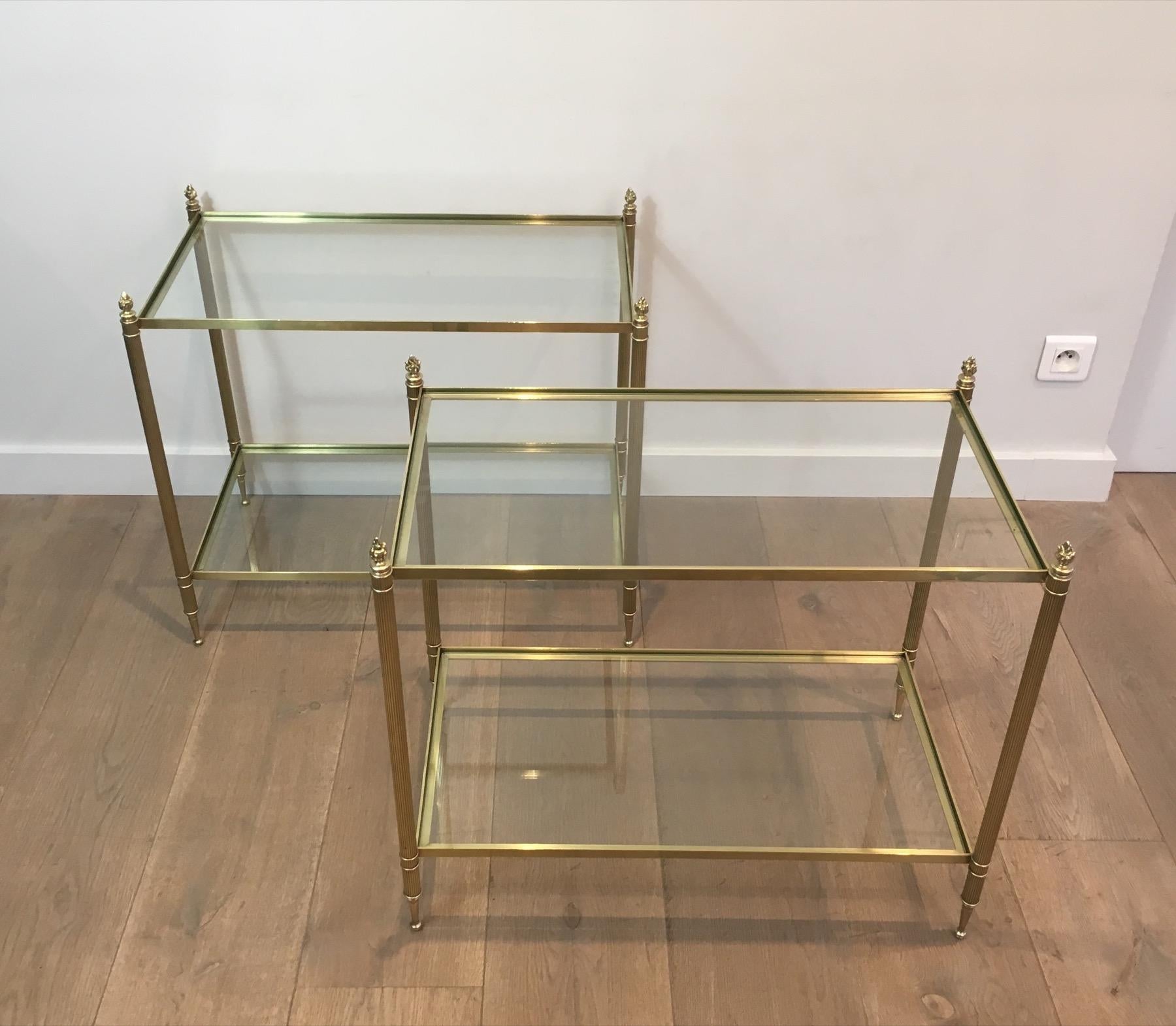 This very nice and large side tables are all made of brass with glass shelves. This is fine work by famous French designer Maison Bagués, circa 1940.