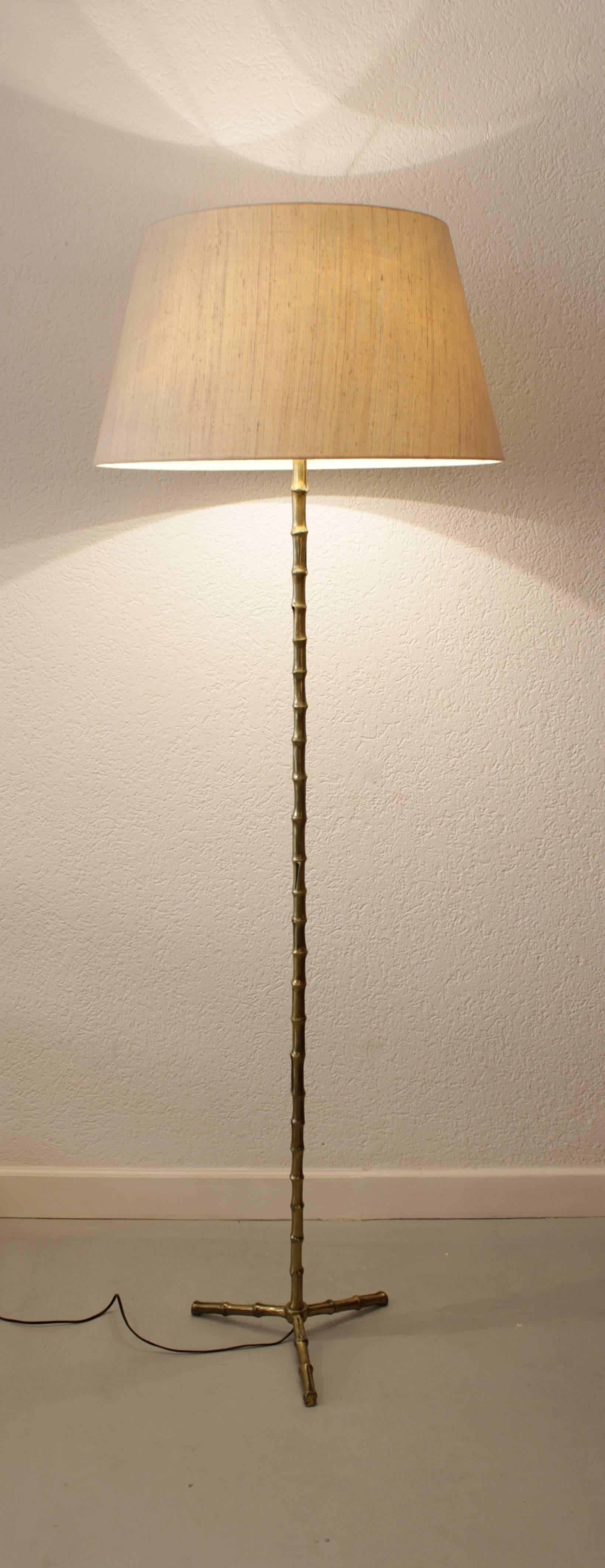Faux bamboo brass floor lamp by Maison Baguès, France, circa 1970
Original fabric shade, perfect condition.
 