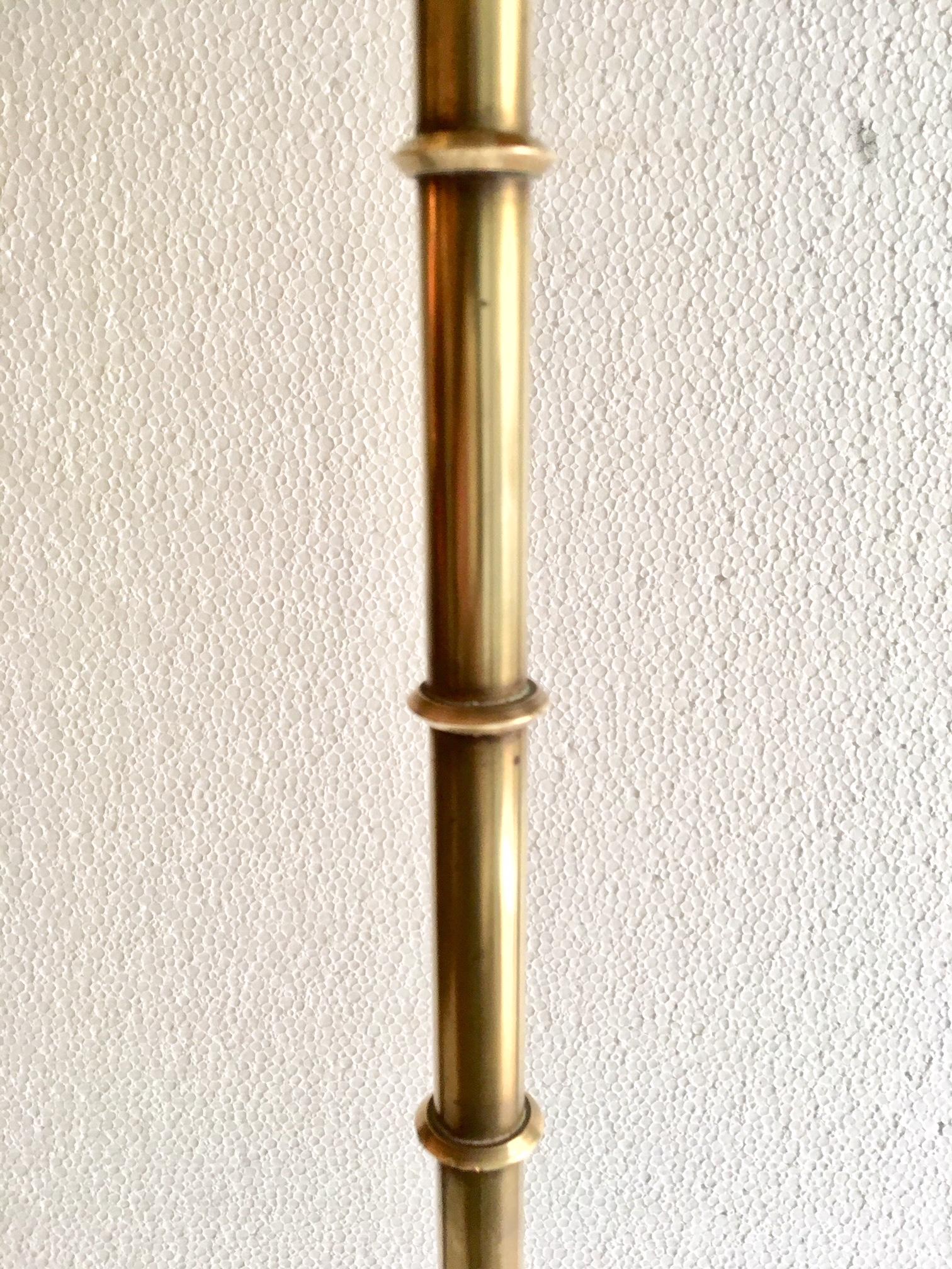 A Maison Baguès faux bamboo floor lamp, made in brass with tripod legs and three lights at the top, shade black and gold interior, restored electricity system and re wired.
 