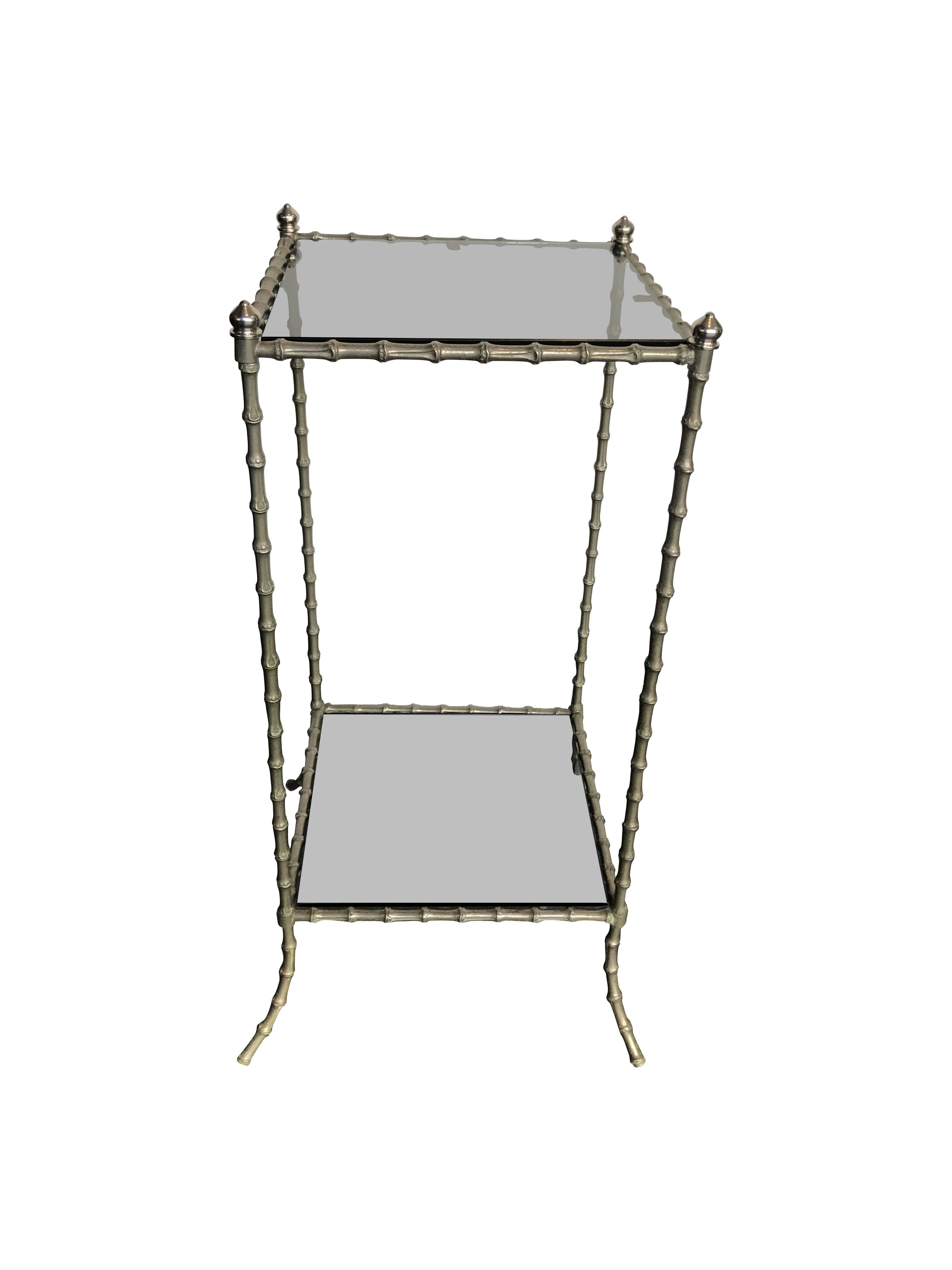 A Maison Baguès faux bamboo side table with nickel frame and two smoked glass shelves. 

Please not the measurements listed are the max width where the feet splay out. The main frame is 30 cm x 30 cm.