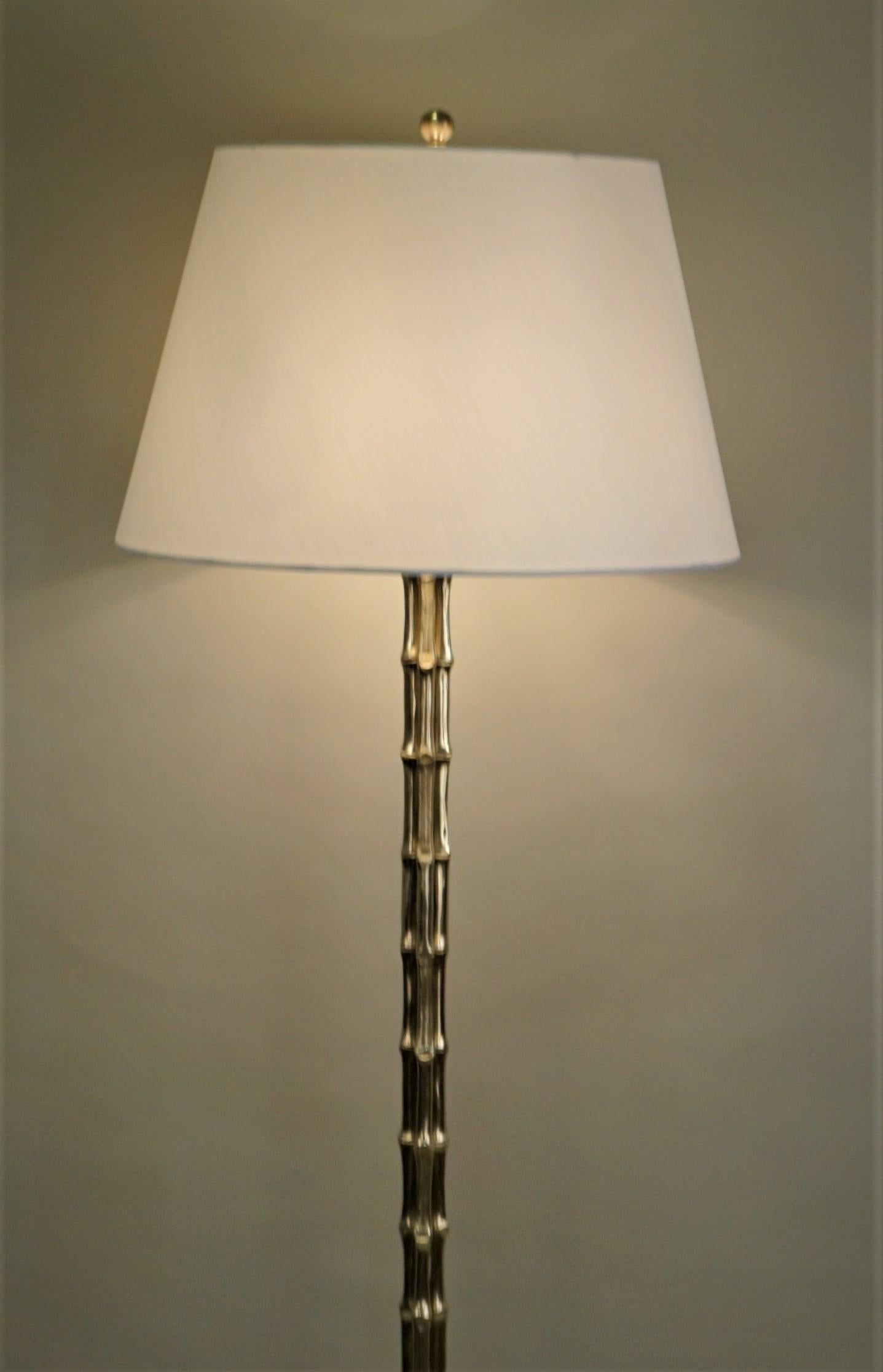 A midcentury bronze faux bamboo floor lamp by Maison Baguès
Modified with three lights, 100 watt each.
Silk hard back lampshade.