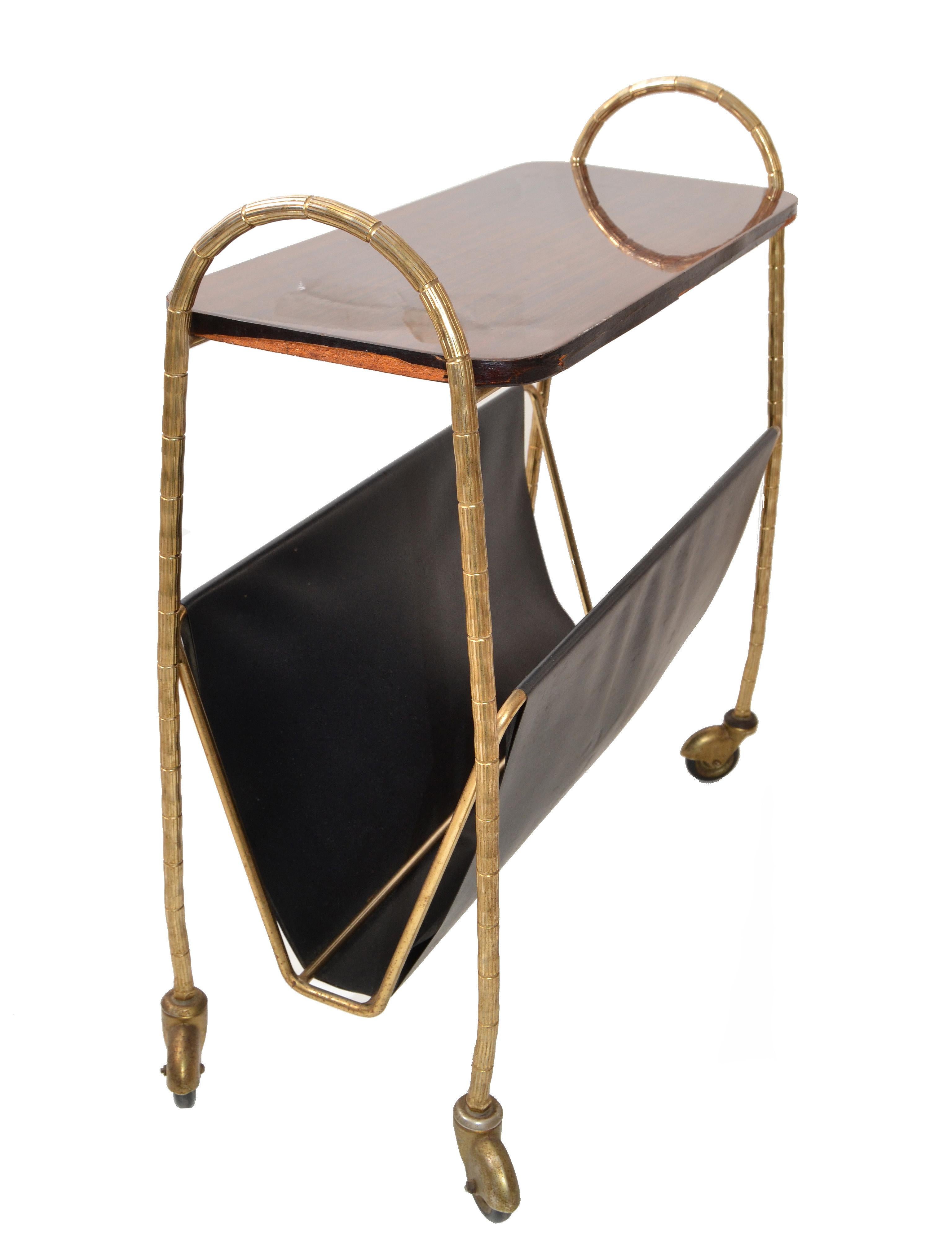 Elegant Maison Baguès French Mid-Century Modern Magazine Rack features Bronze Bamboo style Frame with leather compartment for the magazines.
The Top is laminated Wood with clear lacquer protection.
All original condition and wheels run