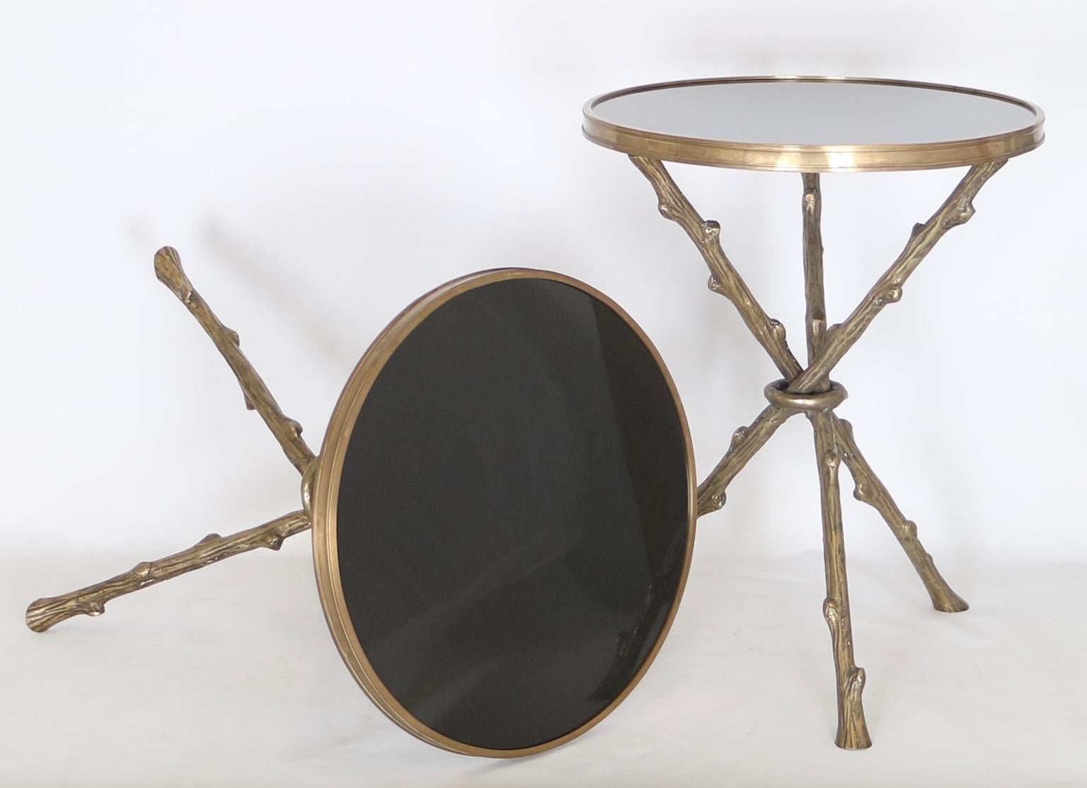 French Hollywood Regency faux bamboo side tables in the style of Maison Baguès.

Has a bronze faux branch tripod base with a round black granite top.

These side tables are in excellent vintage condition and have wear consistent with age and use.
 