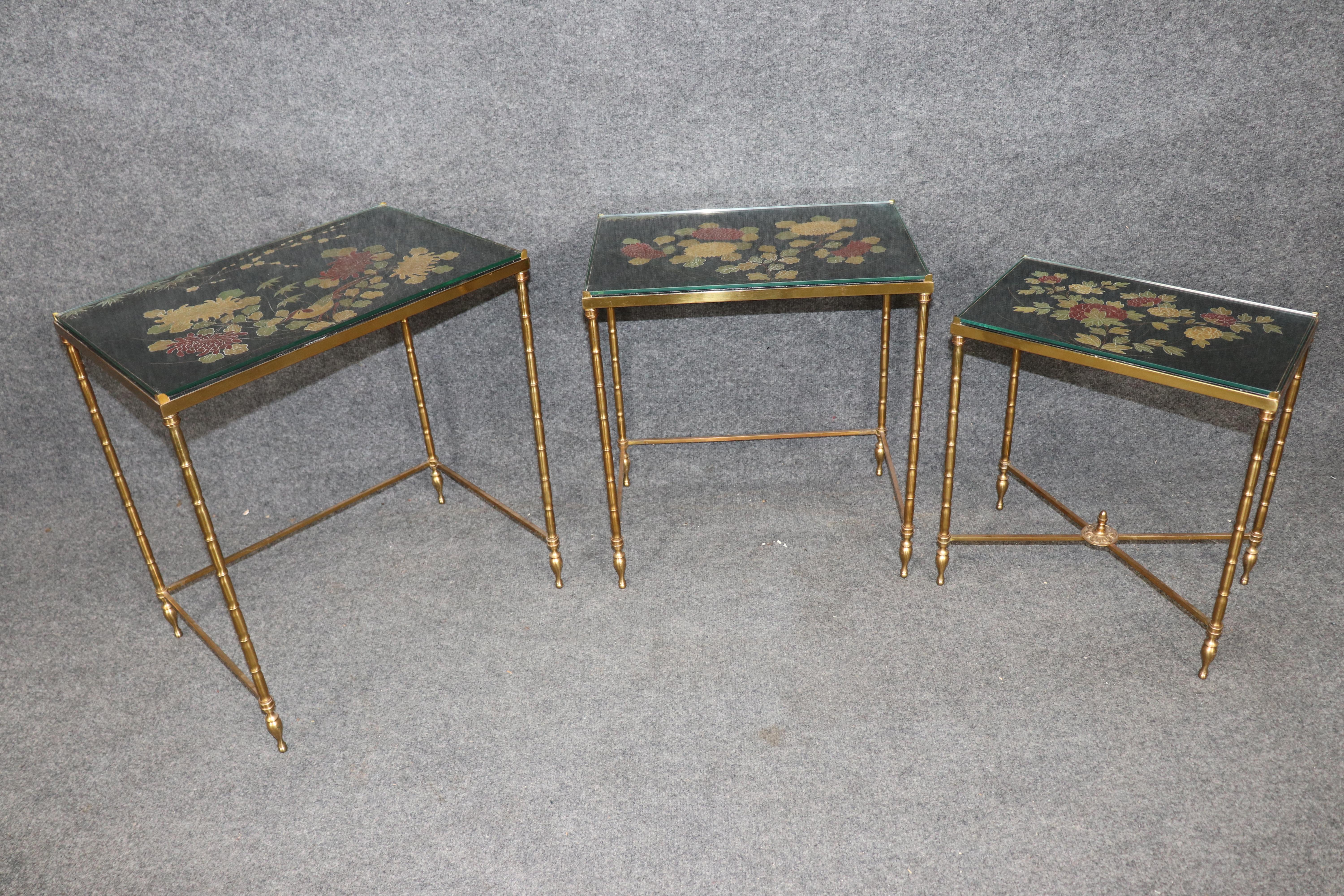 This is a gorgeous set of nesting tables by Maison Jansen in the Chinese Coramandel lacquer taste and faux bambook brass turned legs. The tables are in very good condition and have no major flaws beyond the most minor signs of use and age. This is