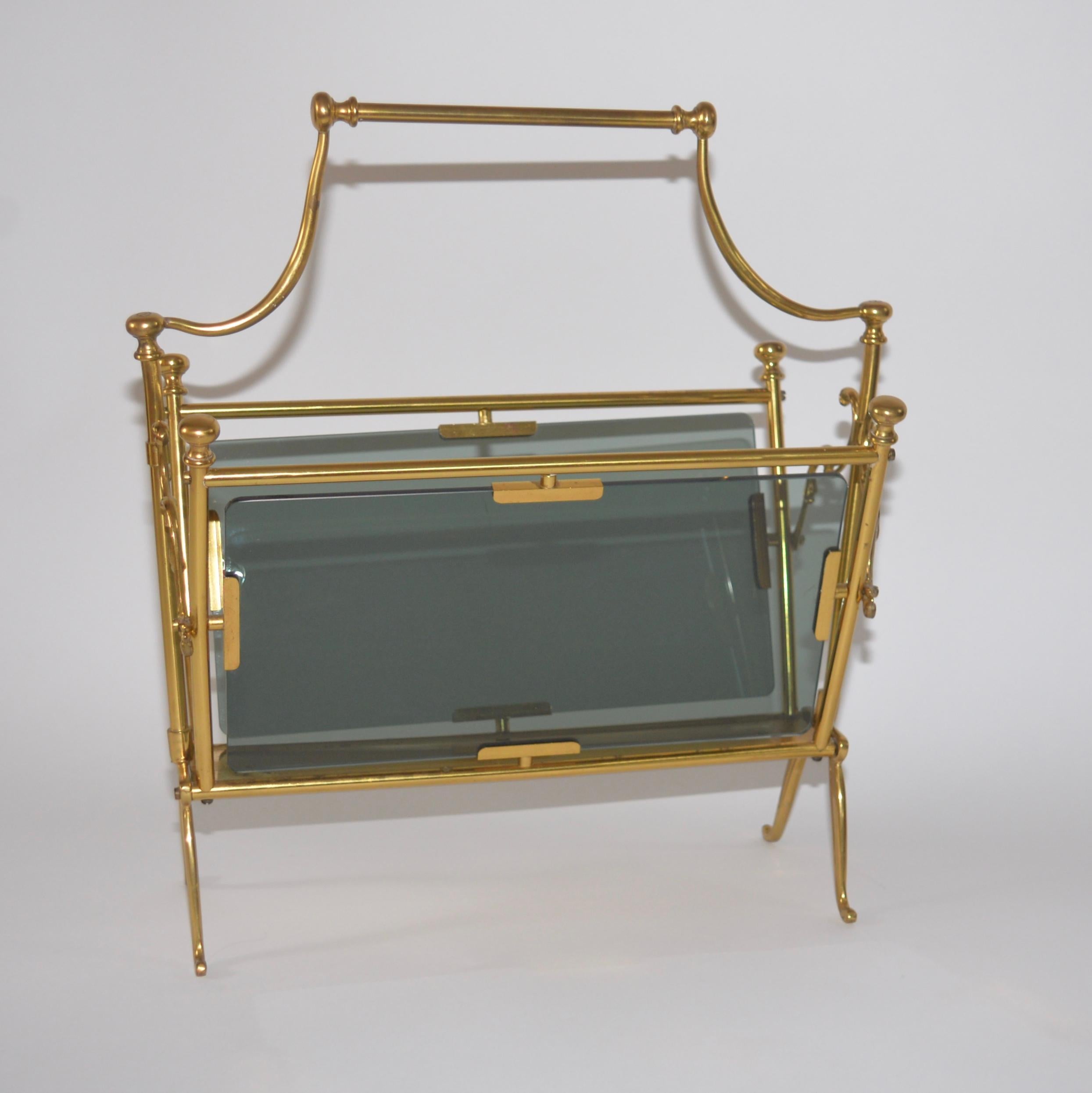 Original French vintage brass magazine rack by Maison Bagues in the Hollywood Regency style. The lovely intricate solid brass frame has scroll features and smoked glass panels. A superb quality item that you would expect from Maison Bagues.