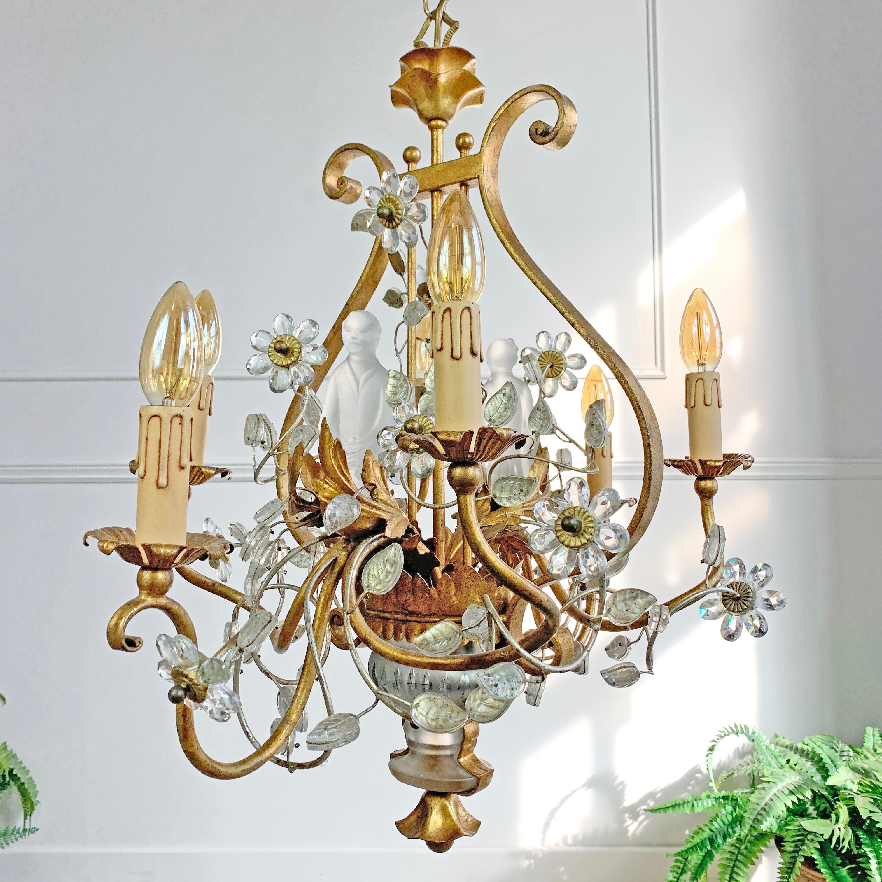 An exceptionally rare Banci Firenze chandelier, gilt iron frame surmounted with crystal leaves and flowers that sit on spiraling golden gilt arms, to the base sit two solid crystal jardinieres, whilst within the body of the light there are a pair of