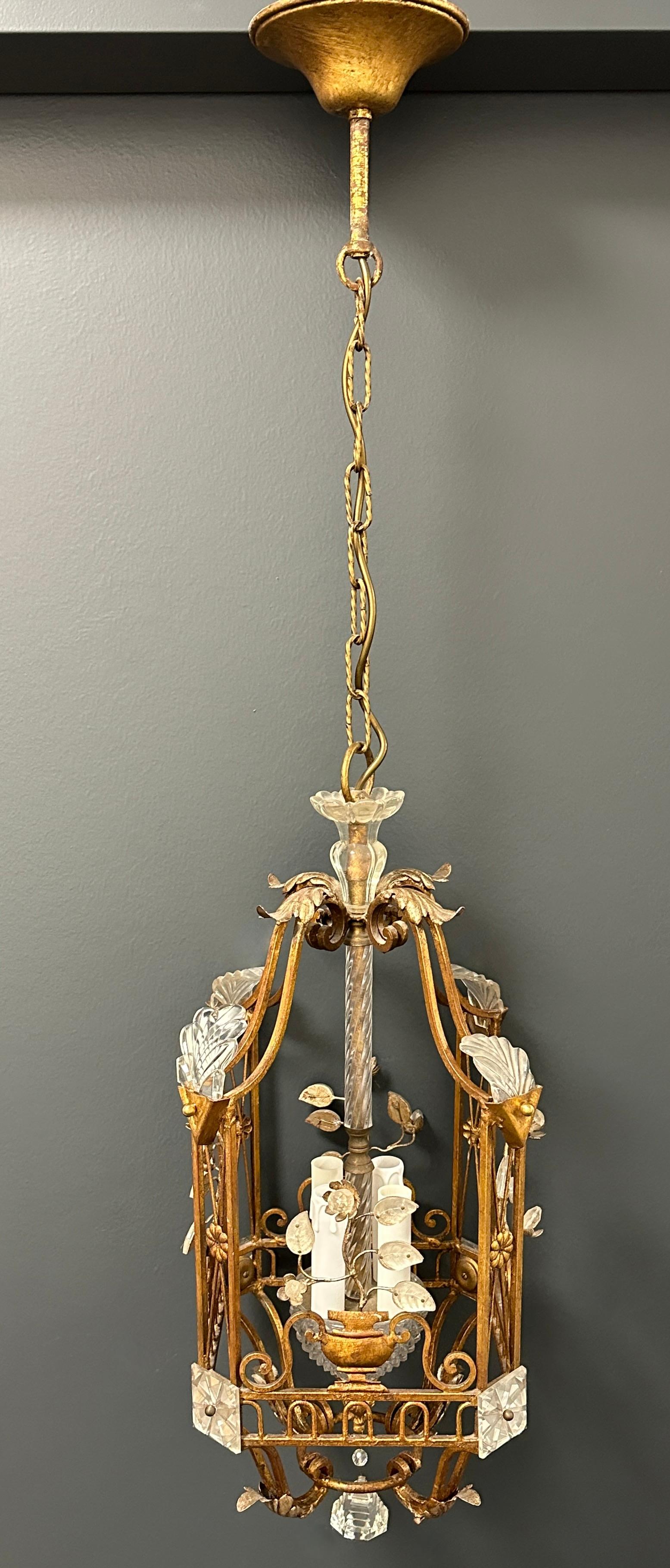 A beautiful Gilt iron and crystal lantern chandelier by the prestigious Maison Baguès.
Square four light handmade gilt bronze with crystal leaves and flora, beautiful piece of art.
Measurement: 12
