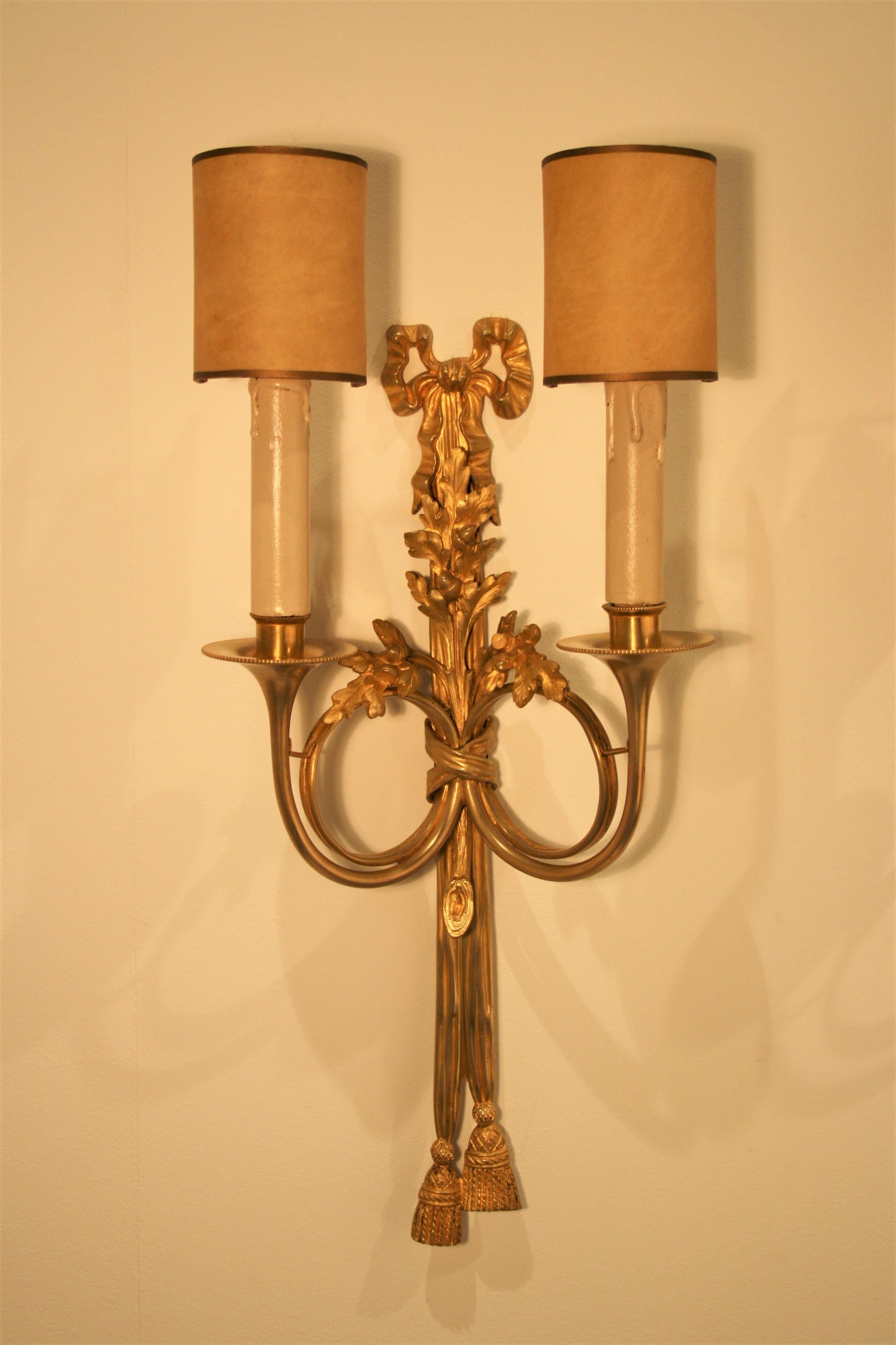 A pair of 24-carat gilt bronze sconces from the famous Maison Baguès in Paris, Louis XVI style.
The bronze is very finely carved and the gilding that used Baguès for these sconces is very rich and has a warm deep color that cannot be compared with