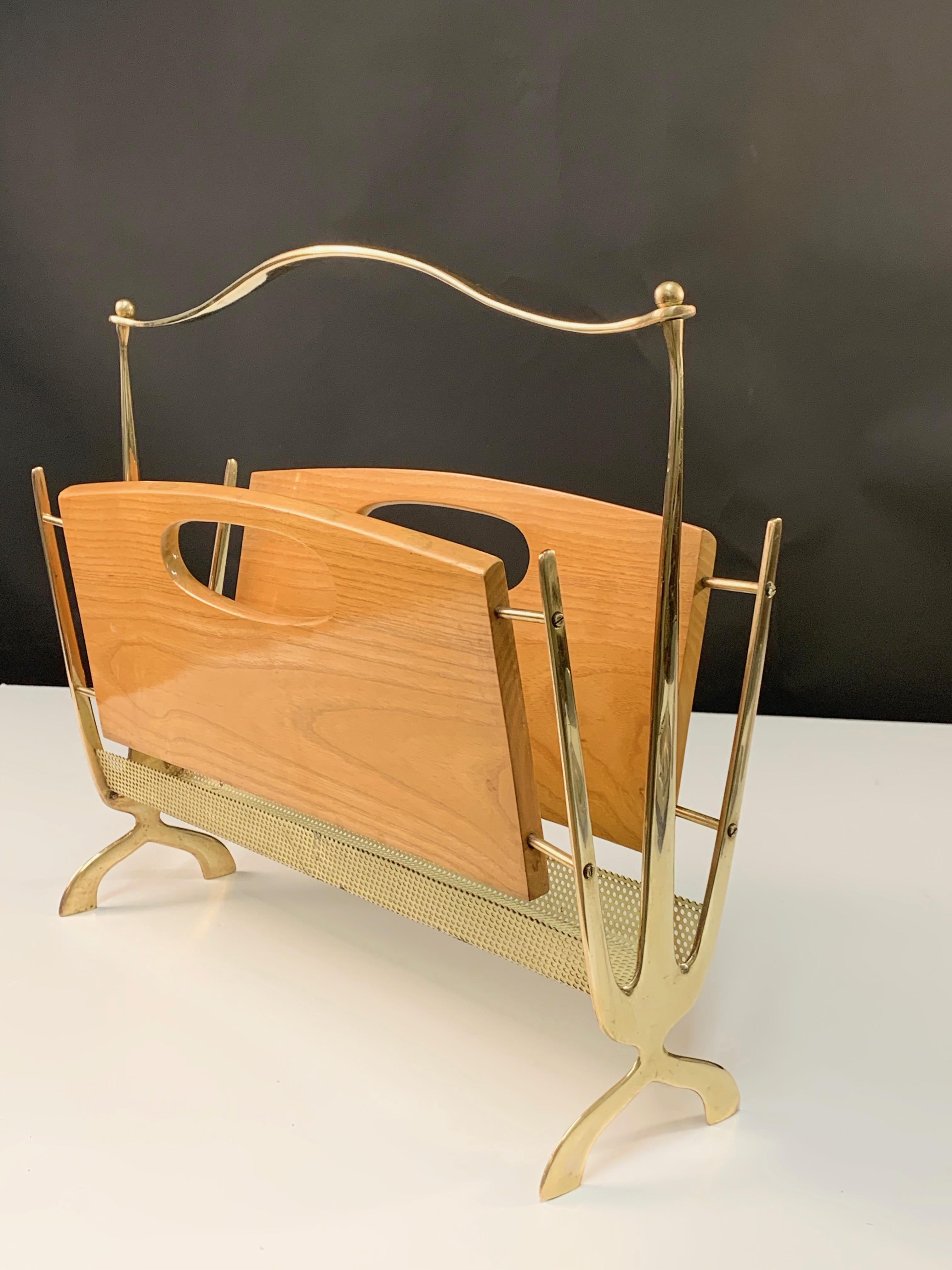 Handmade magazine rack in brass and chestnut wood, beautifully made during the 1950s in France.

Between the two chesnut slabs, you will find your favourite magazines or books laid on the amazing brass structure, that make this timeless piece