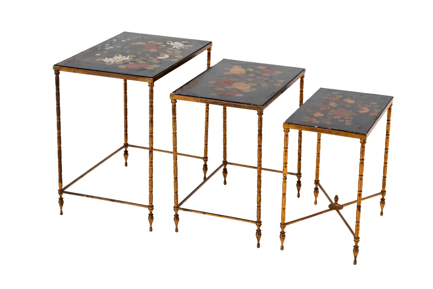 Attributed to Maison Baguès.

Set of three nested tables, in black lacquered wood with a Japanese floral decor of peonies, dahlias, prunus, chrysanthemums and birds in white, green and red shades. Bamboo style gilt brass legs. Three outside