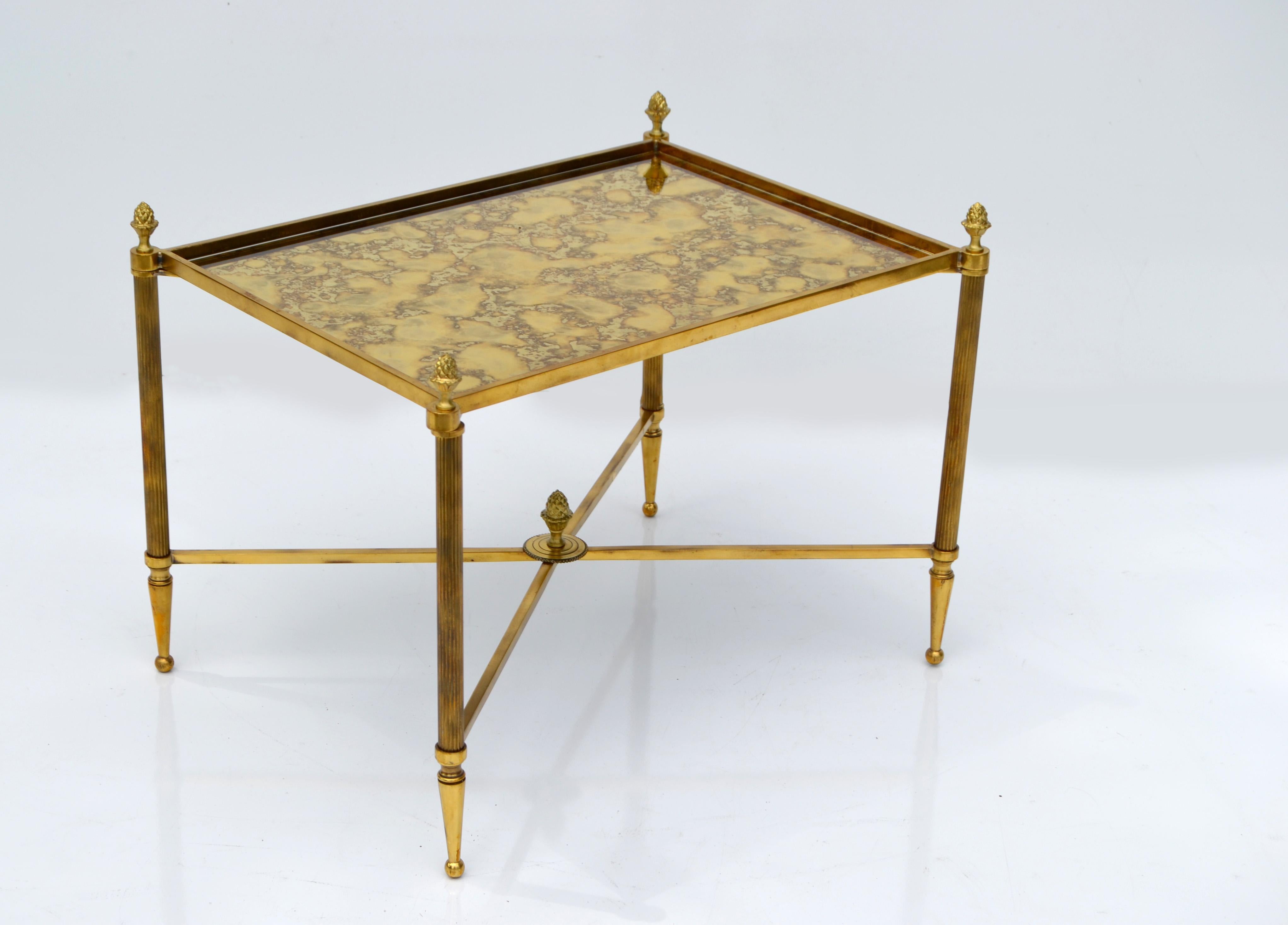 Maison Bagués brass & bronze rectangular side table, end table, sofa table.
Cross Stretcher with decorative Acorn Finial in the Center as base and comes with an antique gold cloudy mirror top.
Tapered Brass Feet and Acorn Finials.
Great for