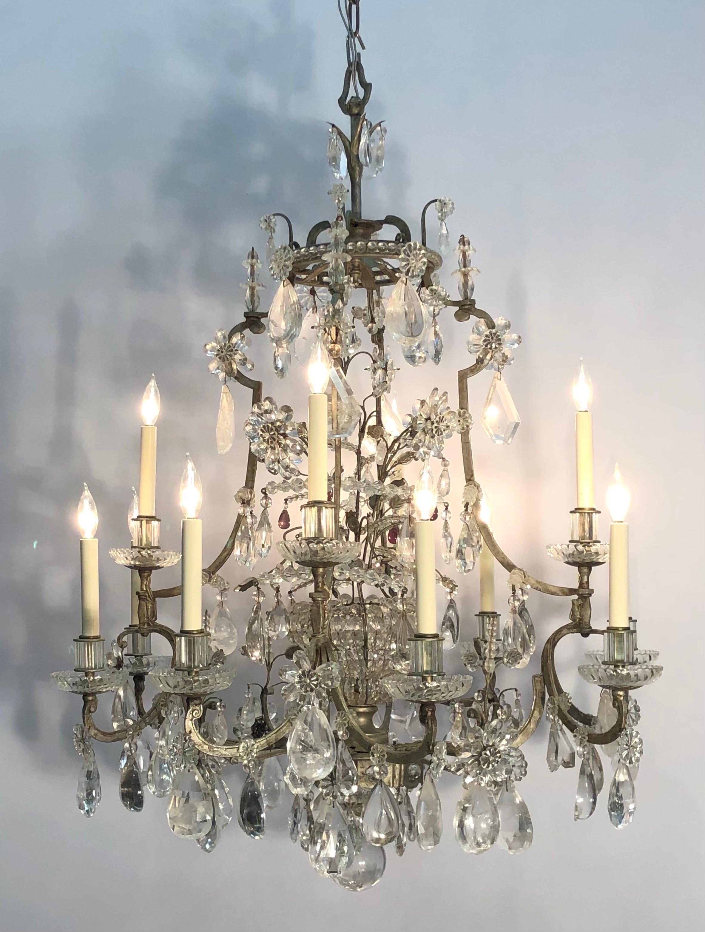 This Grand Maison Baguès silverleaf wrought iron rock crystal chandelier with twelve lights was hand assembled using traditional techniques. The Fashionable Baguès chandelier has a silverleaf wrought iron frame in the chinoiserie taste that is