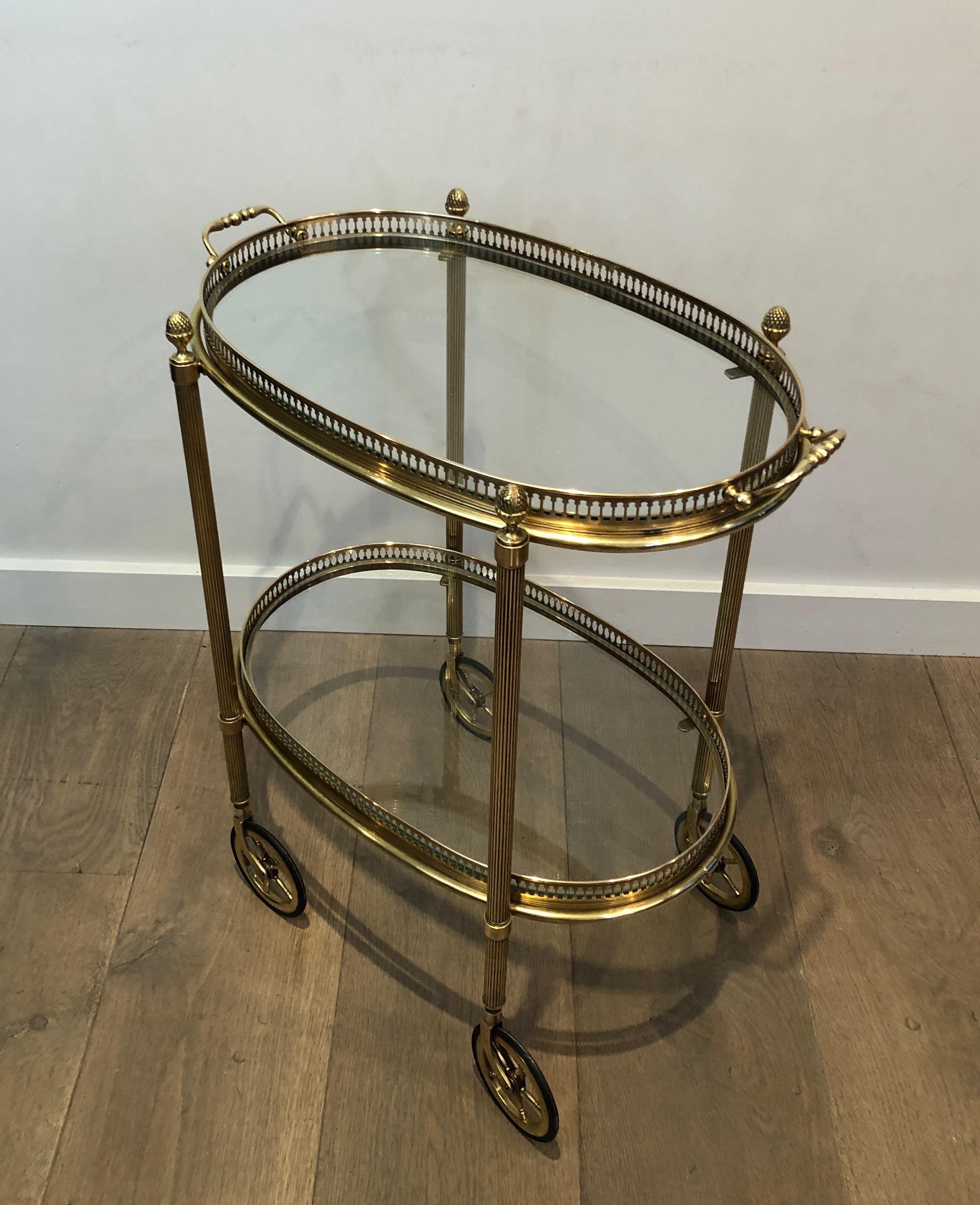 This very nice neoclassical small oval brass bar cart is made of brass with 2 removable trays. This drinks trolley was made by famous French designer Maison Baguès, circa 1940.