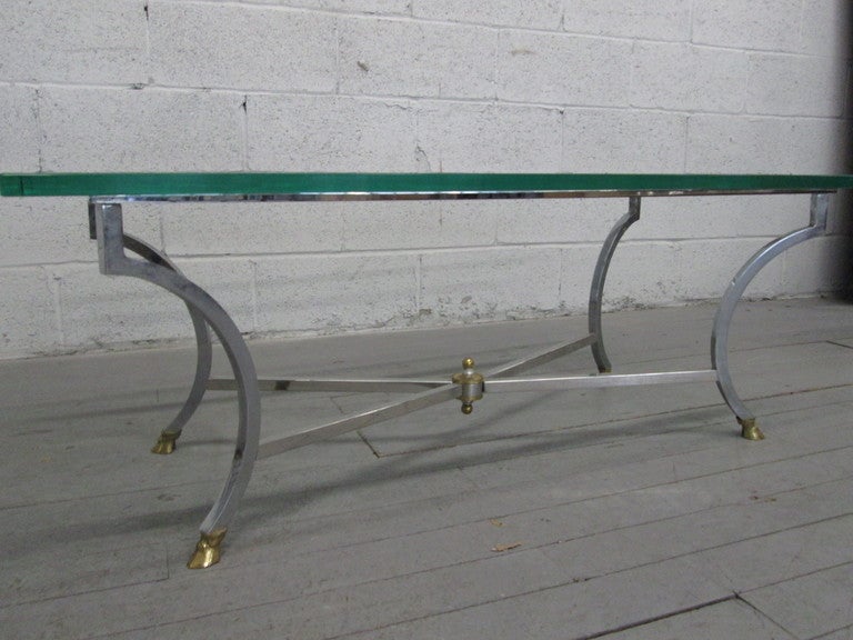 Steel and brass Maison Baguès coffee table with a rectangular shaped glass top.