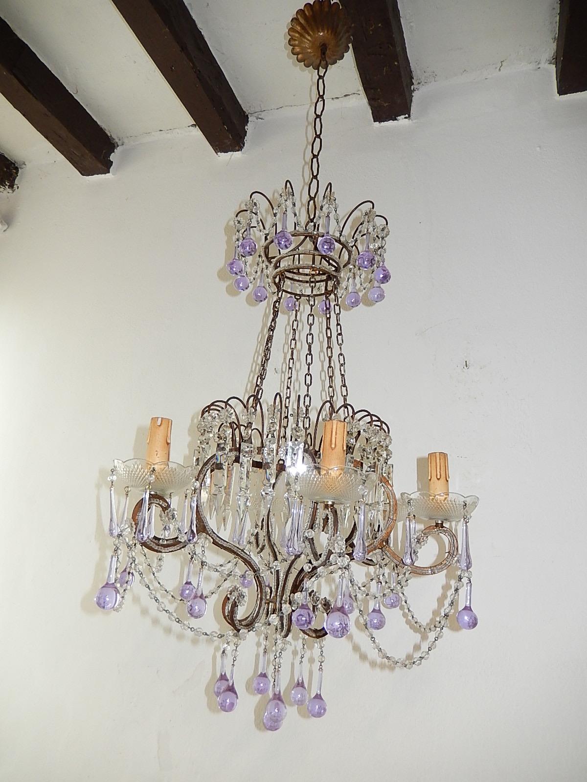 Housing six-light, will be rewired with appropriate sockets for country and ready to hang. Bobeches dripping with lavender Murano drops. Gilt metal with beading throughout. Spear prisms and florets with chains. Adorning bigger lavender Murano drops.