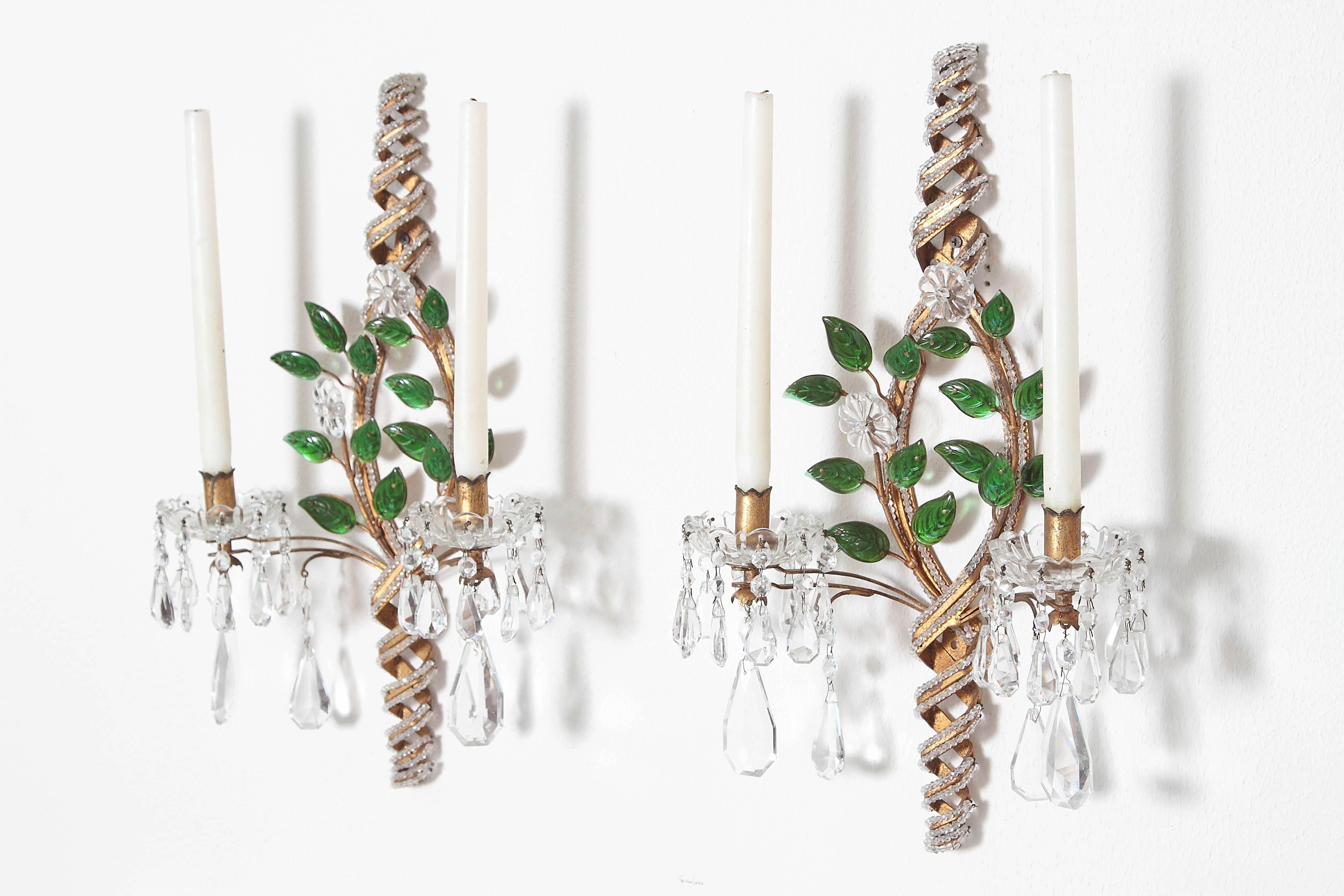 A charming pair of Baguès style sconces with twisted, beaded back supports with two (2) lights. Crystal drops and glass leaves and flowers decorate the sconces.