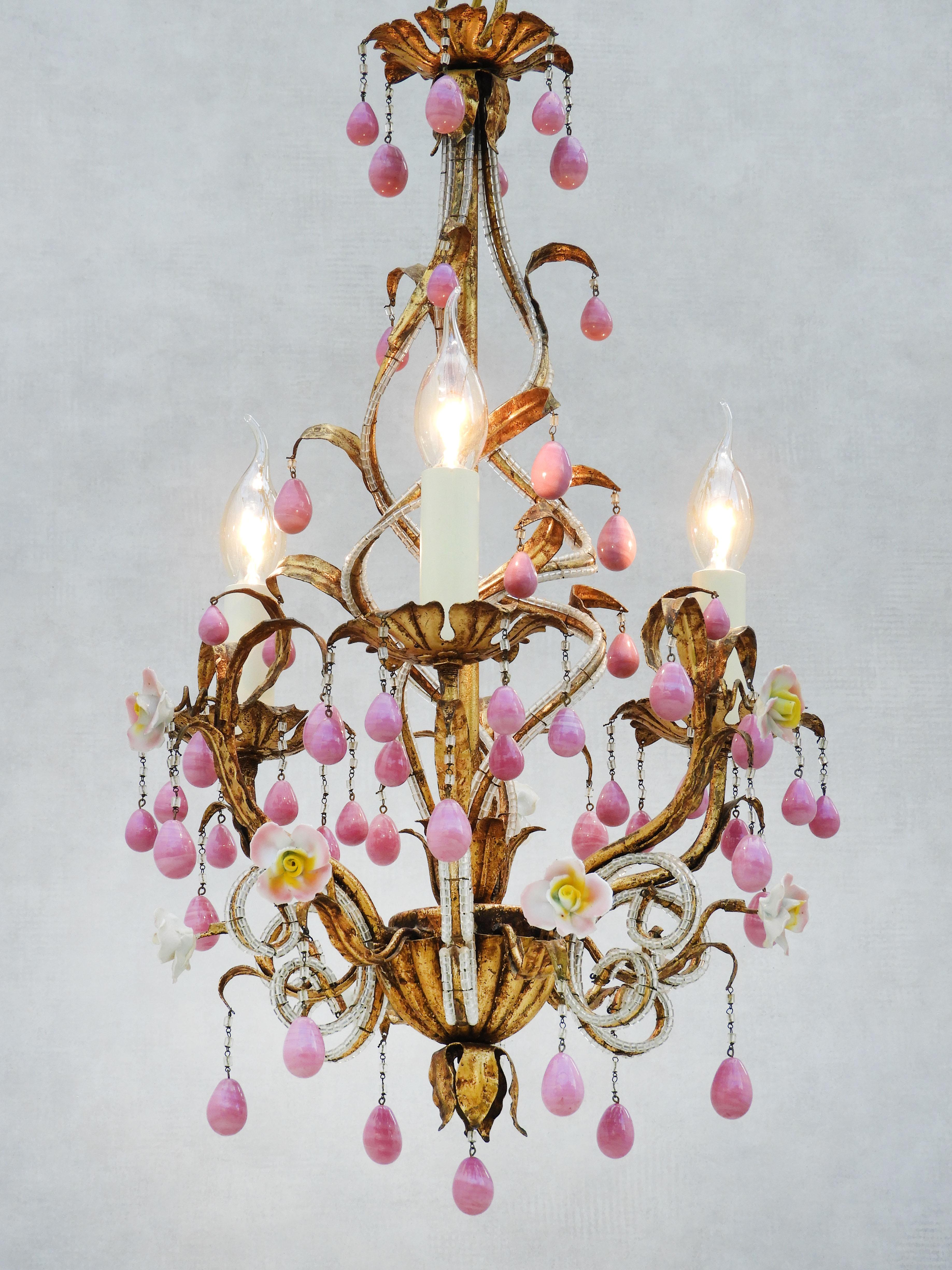 Beautiful Maison Baguès style three light Chandelier c1960. Gilded tôle helix frame, trimmed with crystal beading, surrounded by three 'faux' candlelights adorned with delicate porcelain rose blooms and pink porcelain 'pampille' drops.  In very good