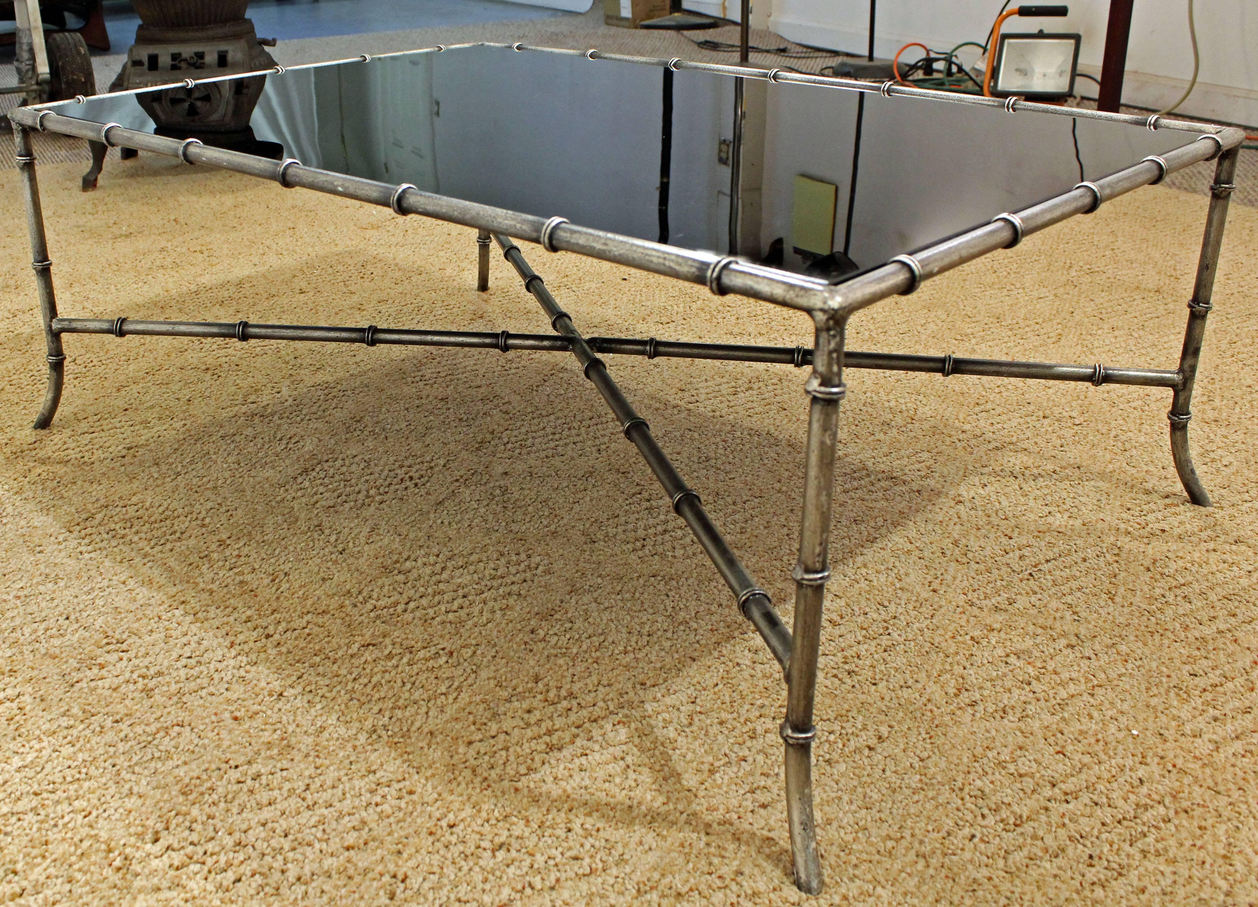 Offered is a Maison Baguès style faux bamboo iron glass top coffee table. This table has an iron base with a blacked-out glass top. It is in great condition, shows minor wear (small scratches on glass -- see pictures). It is not marked. Check out
