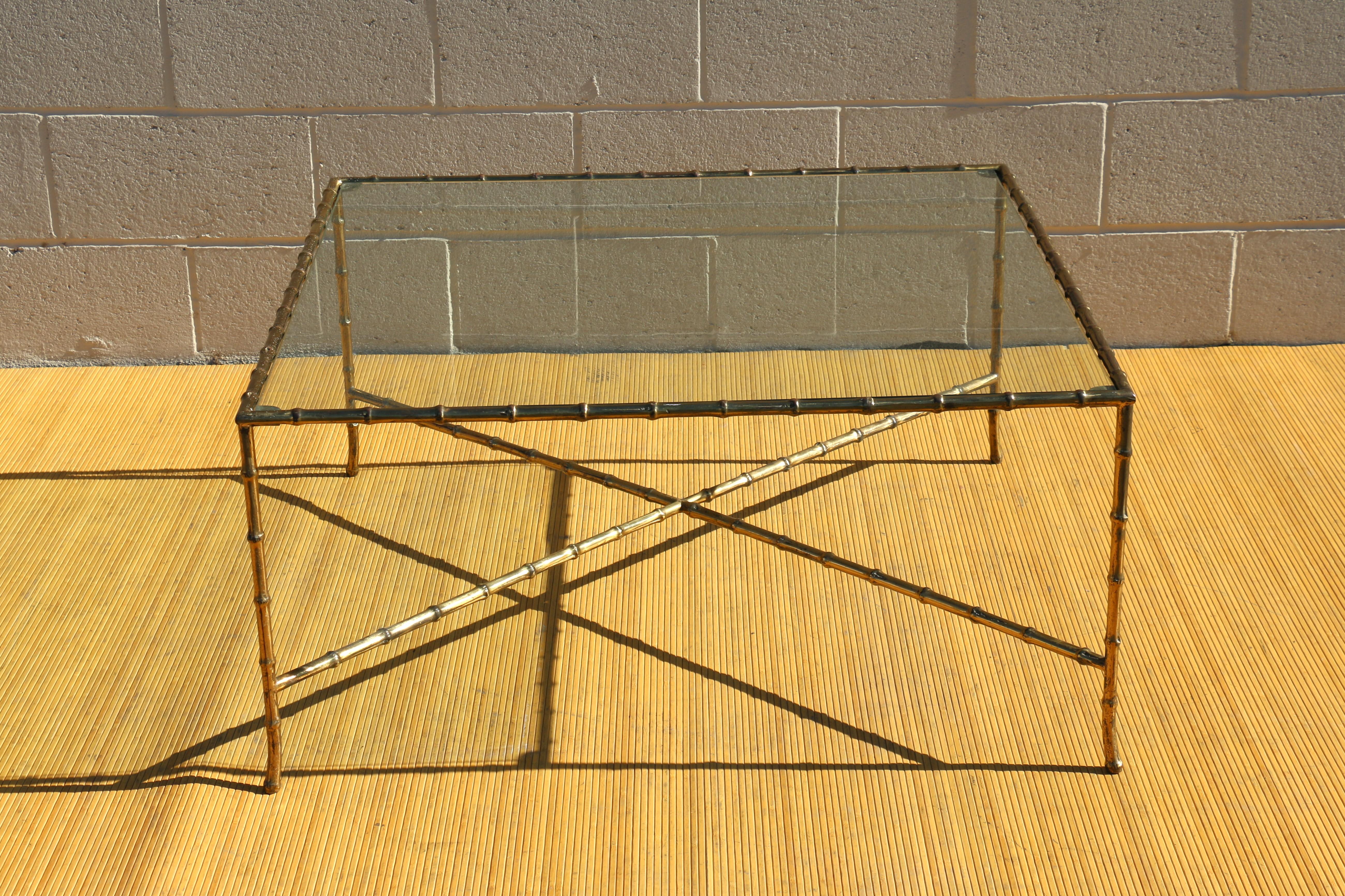 Wonderful 1950's solid brass faux bamboo square coffee table with glass top, in vintage condition with some wear and patina due to age and use. The glass has some scratches but not chips. Very strong and sturdy. Absolutely nice looking table.