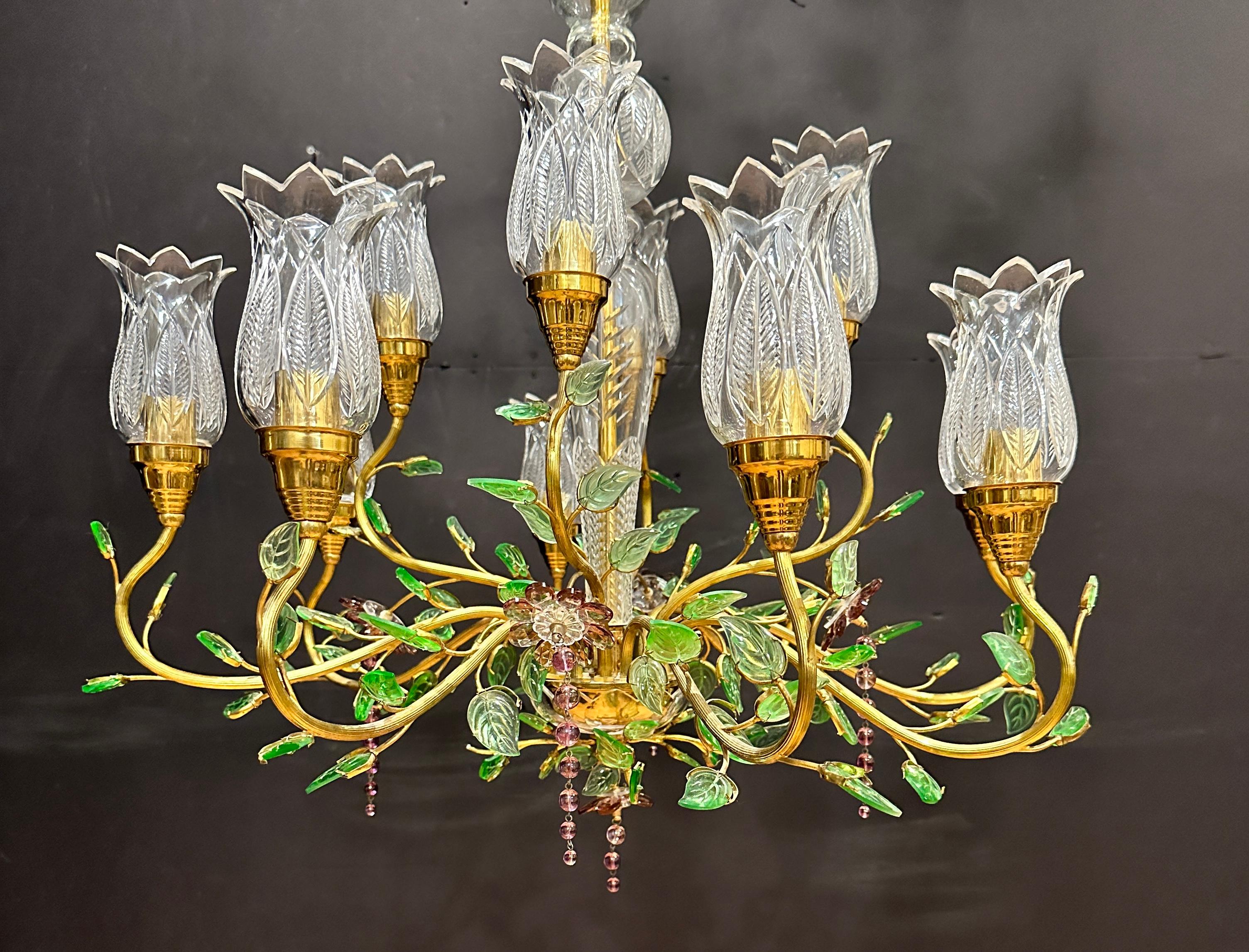 Amazing and absolutely rare twelve-light chandelier with clear cut glass tulip form shades. Attributed to Maison Baguès, France, circa 1970 with green and amethyst glass flowers and leaves  This beautiful handcrafted fixture is made of gilded brass,
