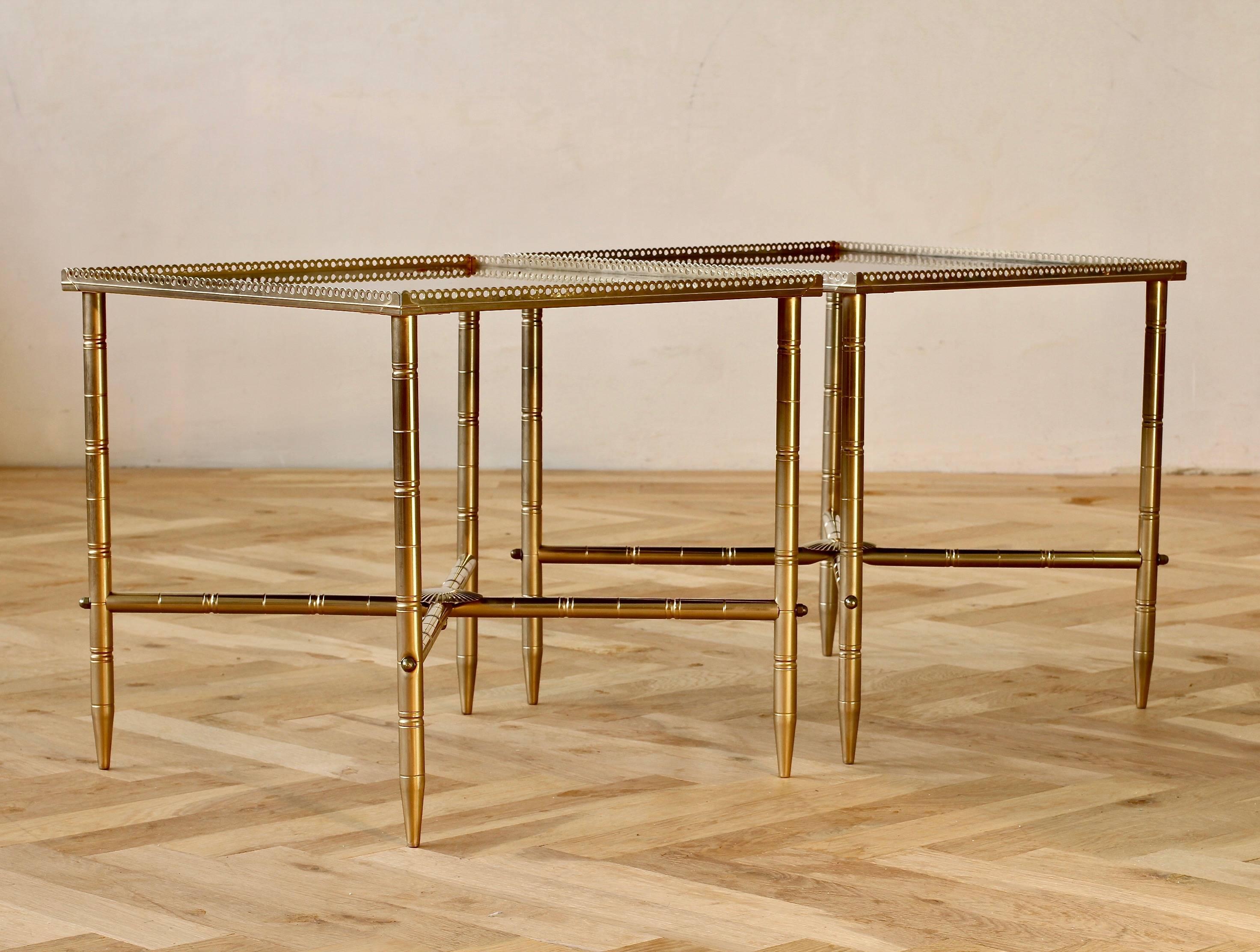 A delightful pair of vintage French midcentury side tables in the style of Maison Baguès, circa 1970s. Featuring perforated metal banding around the tabletop and 'lathed' style details on the legs and cross sections. The table tops are simply