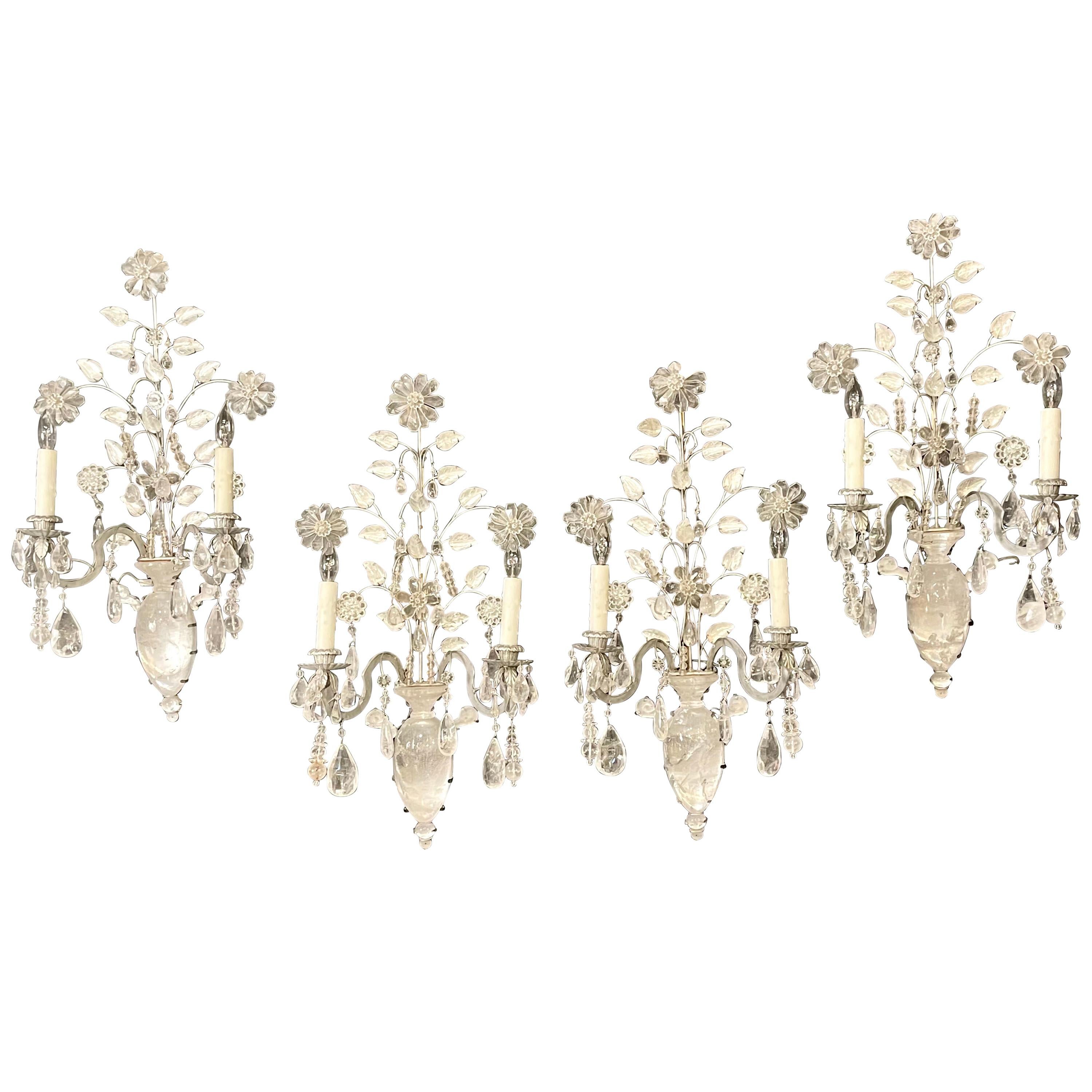 Two pair of rock crystal wall sconces. A fine set of four, prices per pair, of rock crystal wall lights / sconces. Each having a large rock crystal center basket and flowing rock crystal flowers and leafs. Each having two lighted bulbs.