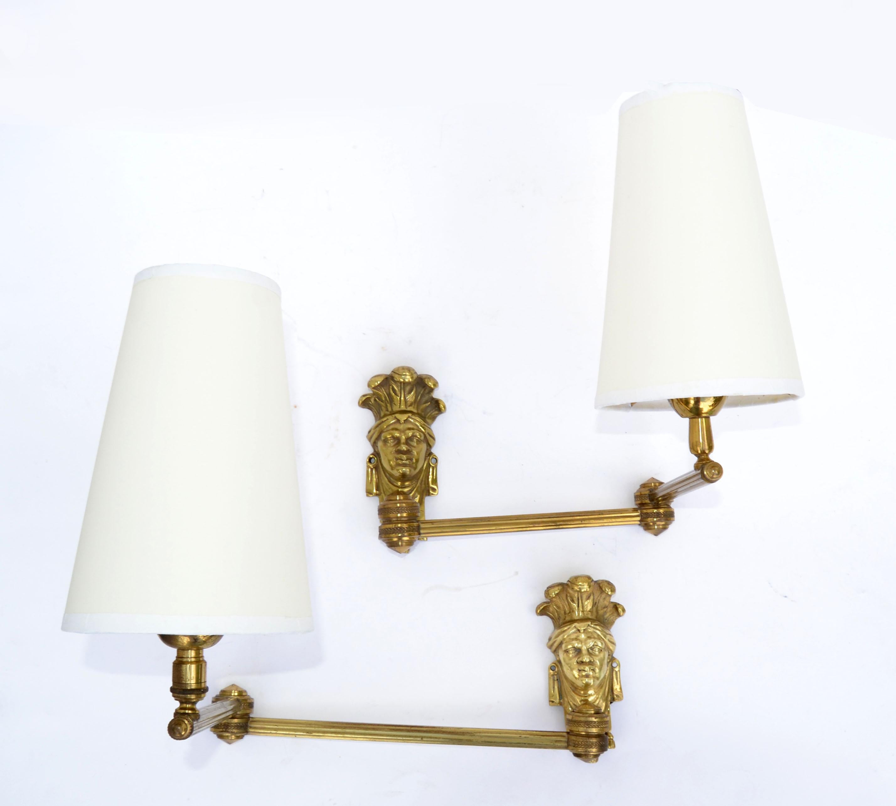 Superb set of bronze Bedouin head swing arm wall sconces.
The cone off-white shades are included.
Working condition and each takes 1 light bulb max. 60 watts.
Dimension without shade: 11 height, 5 depth, 18 inches width.
Cone Shade measure: top