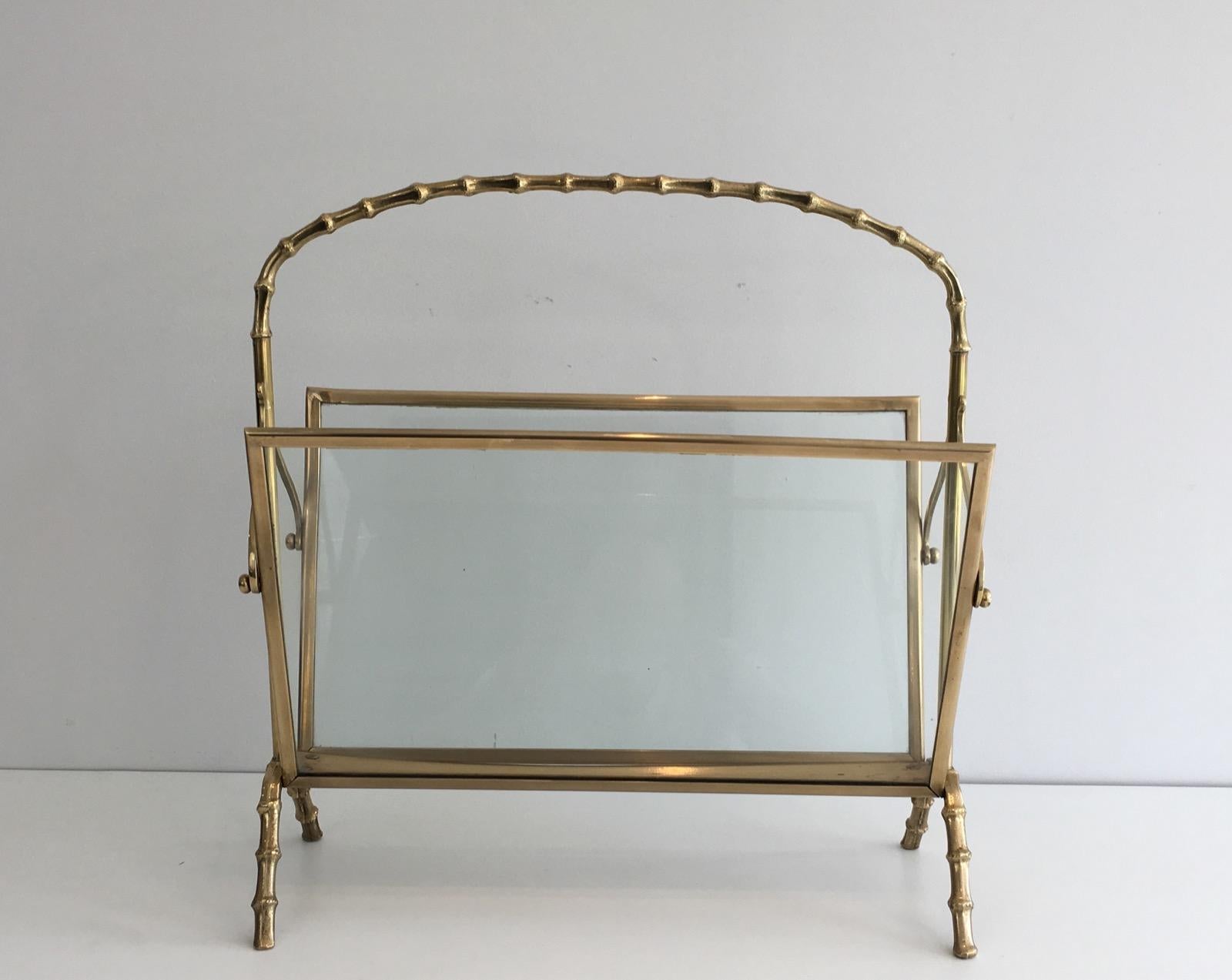 This very nice neoclassical magazine rack is made of bronze in the faux-bamboo style with glass panels on each side. It is a French work by famous French Maison Bagués, circa 1940.