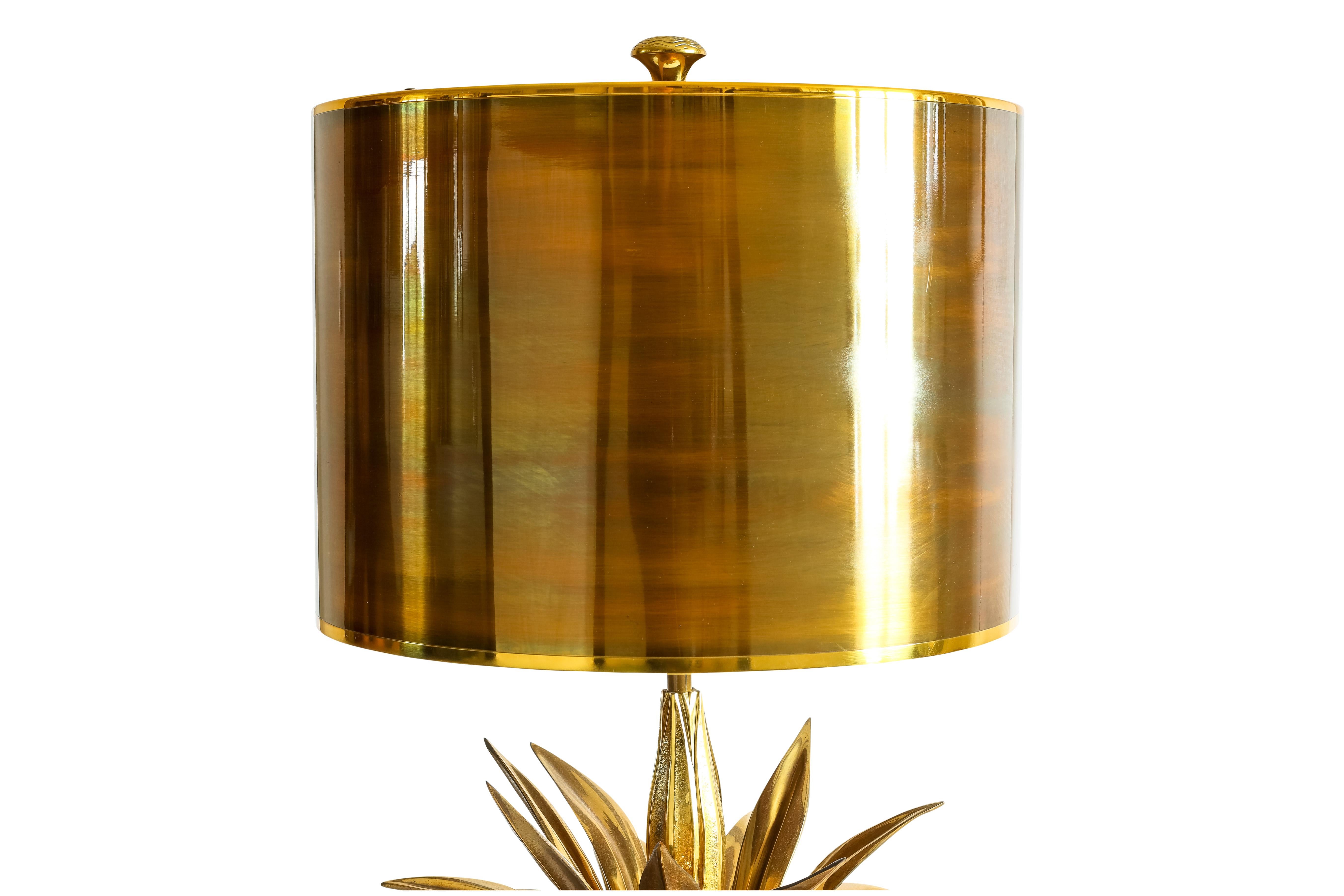 Impressive by its scale, this lamp was designed by Maison Charles. The lamp  is in the Maison Charles catalogue. The base and the circular shade are in brass and the floral ornament is in bronze. There is a variation of tones between the central