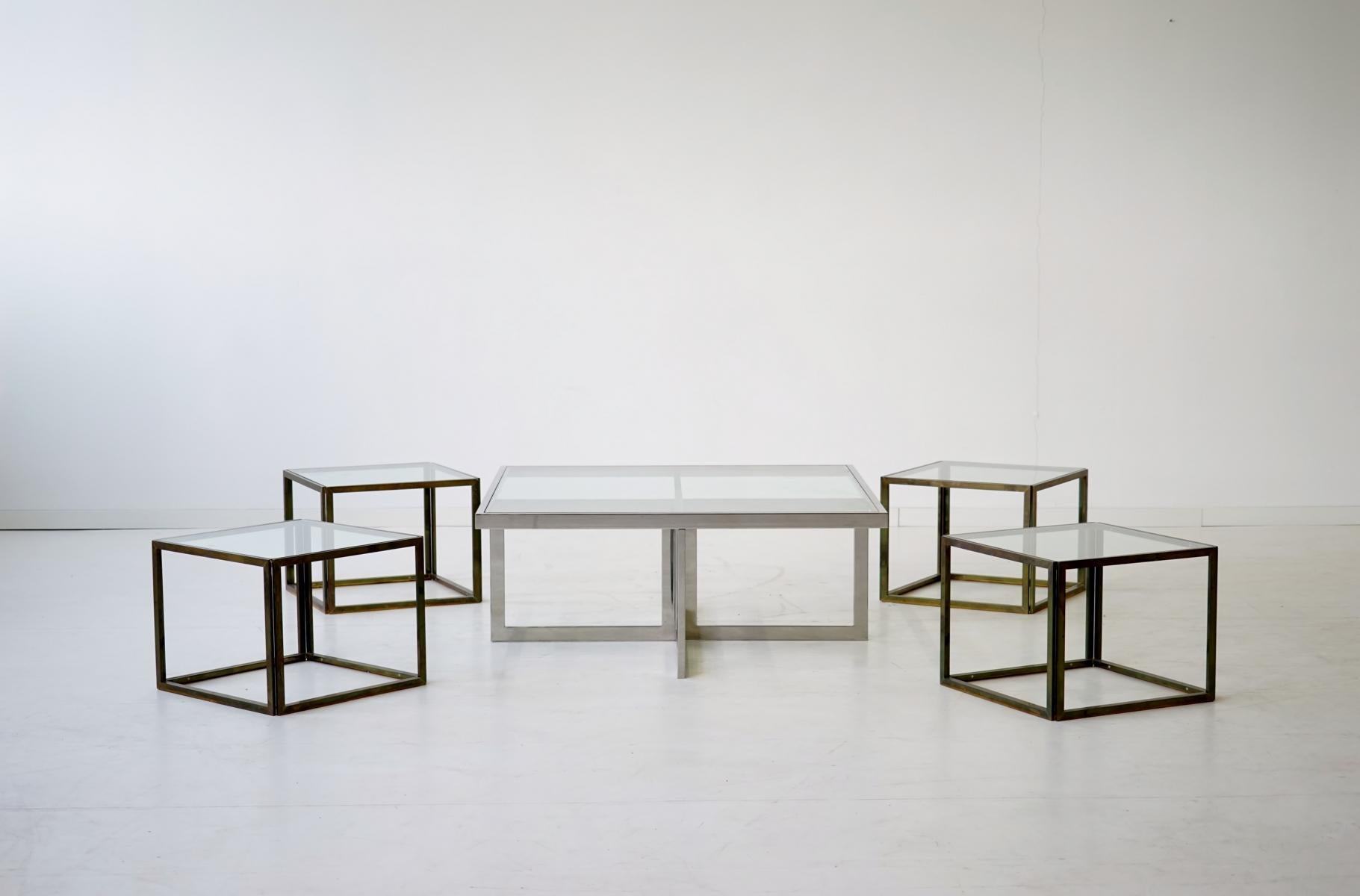 Maison Charles brass coffee table with four nesting tables, 1960s

Rare and elegant chrome/ glass coffee table with four nesting tables in brass and chrome, made by Maison Charles.
The tables are in very good condition. Only light signs of use and