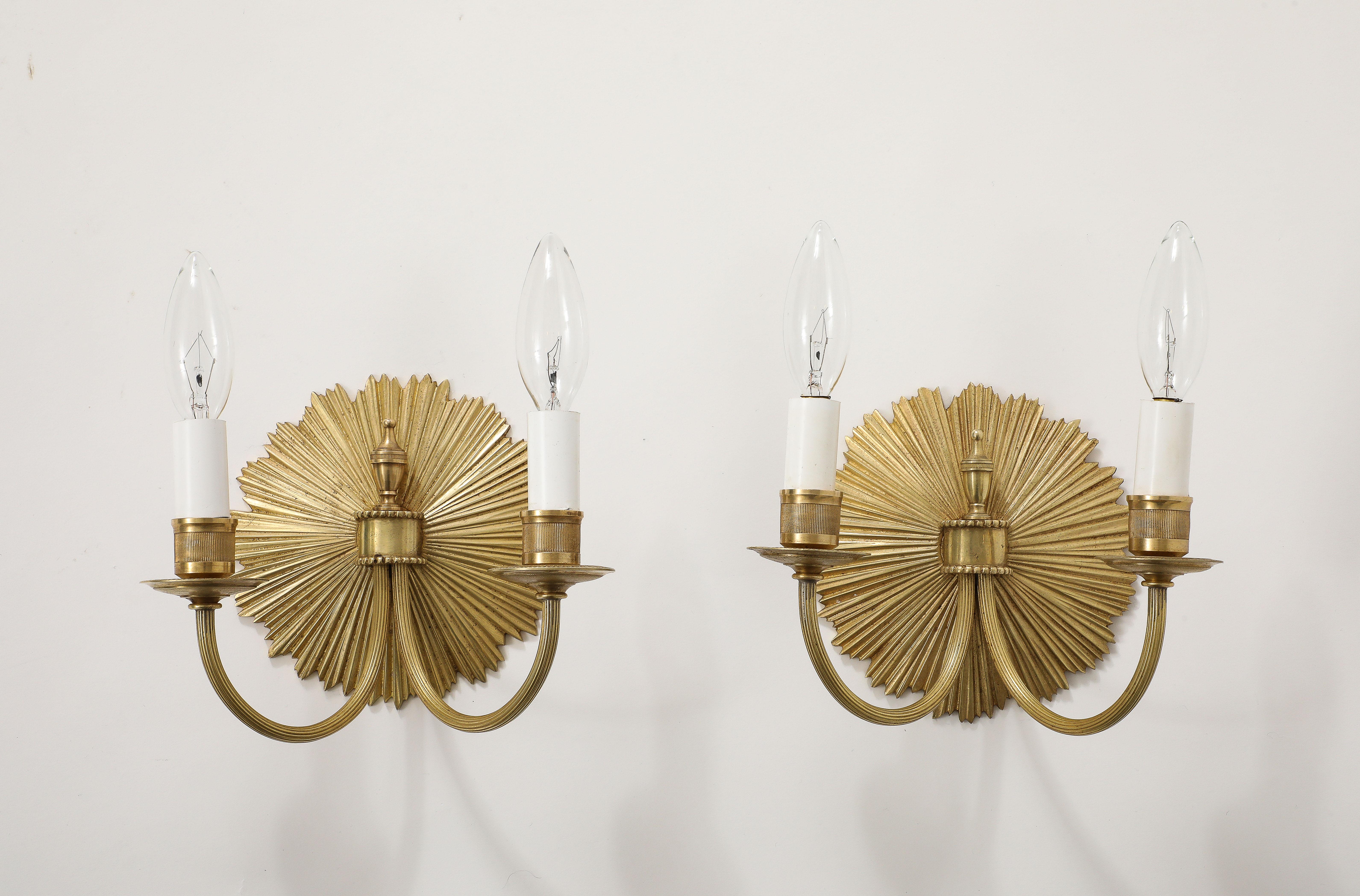 Beautiful pair of 1950's Maison Charles brass French wall sconces, newly rewired and lightly polished with minor wear and patina due to age and use.
