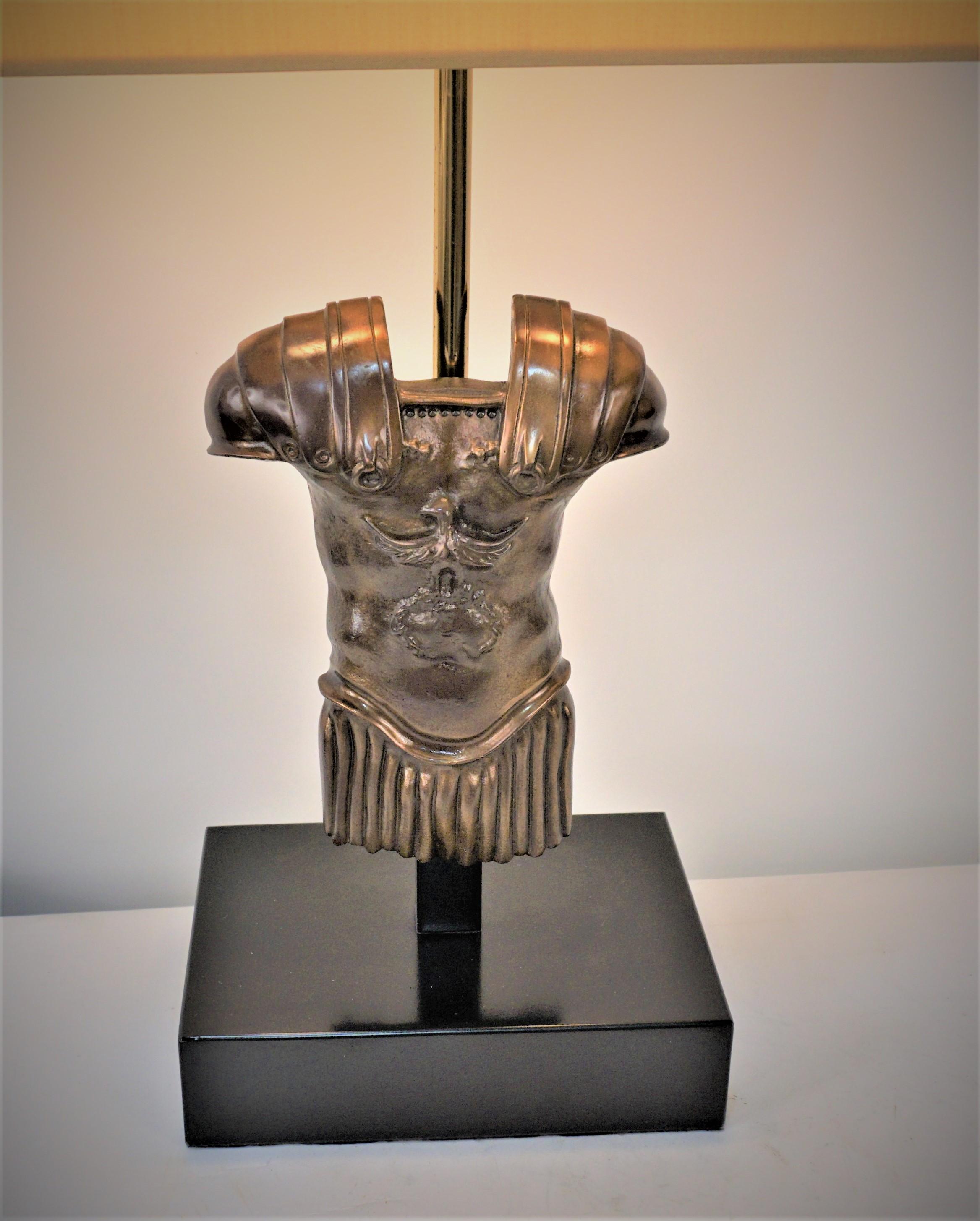 Bronze body armer table lamp with black base and silk lampshade.
Measurement includes the lampshade.