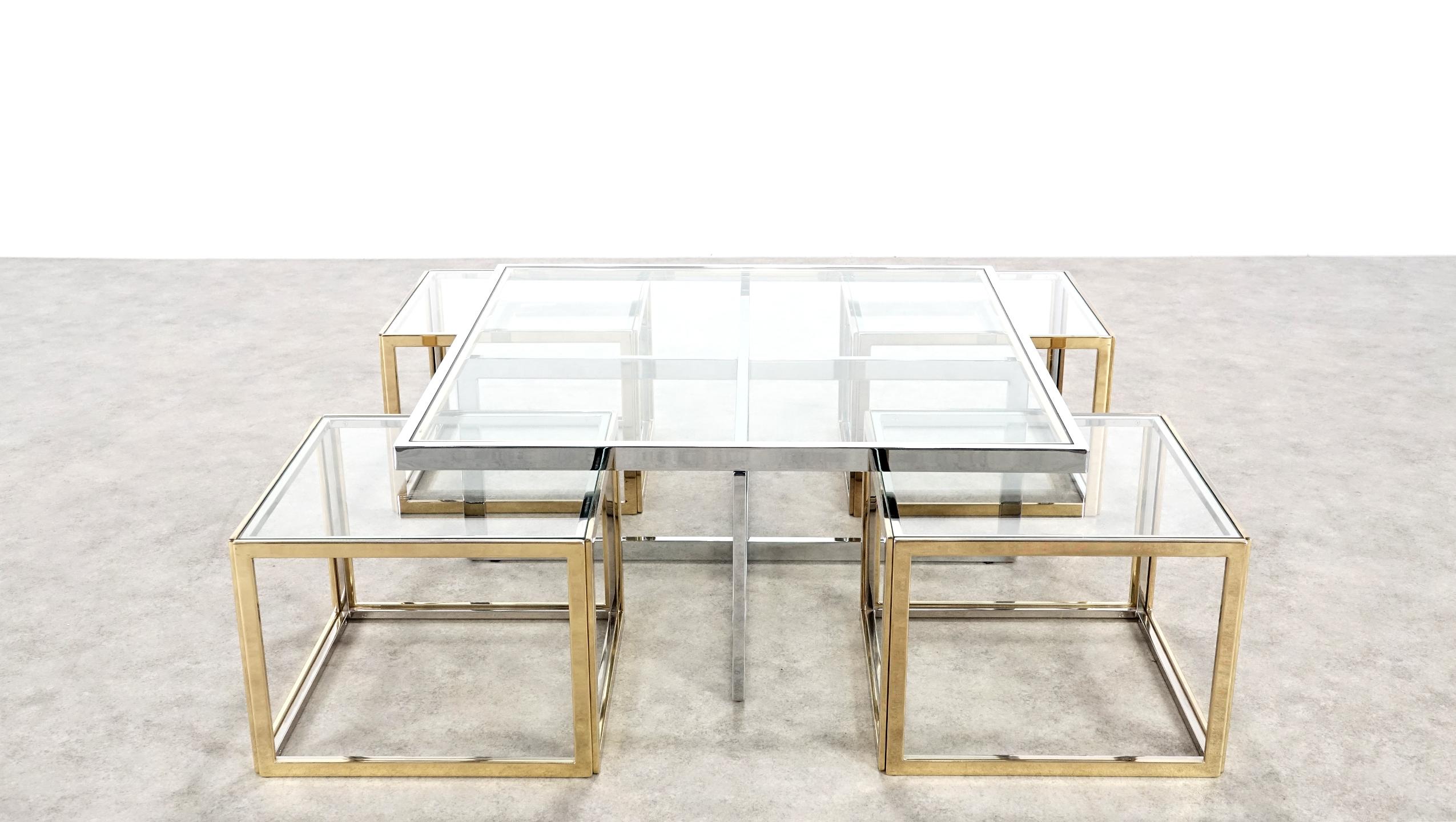 Elegant Maison Charles coffee table with four nesting tables in brass and chrome. 
This set is a real eyecatcher for your interior and for every reception!

The glass are in good condition.