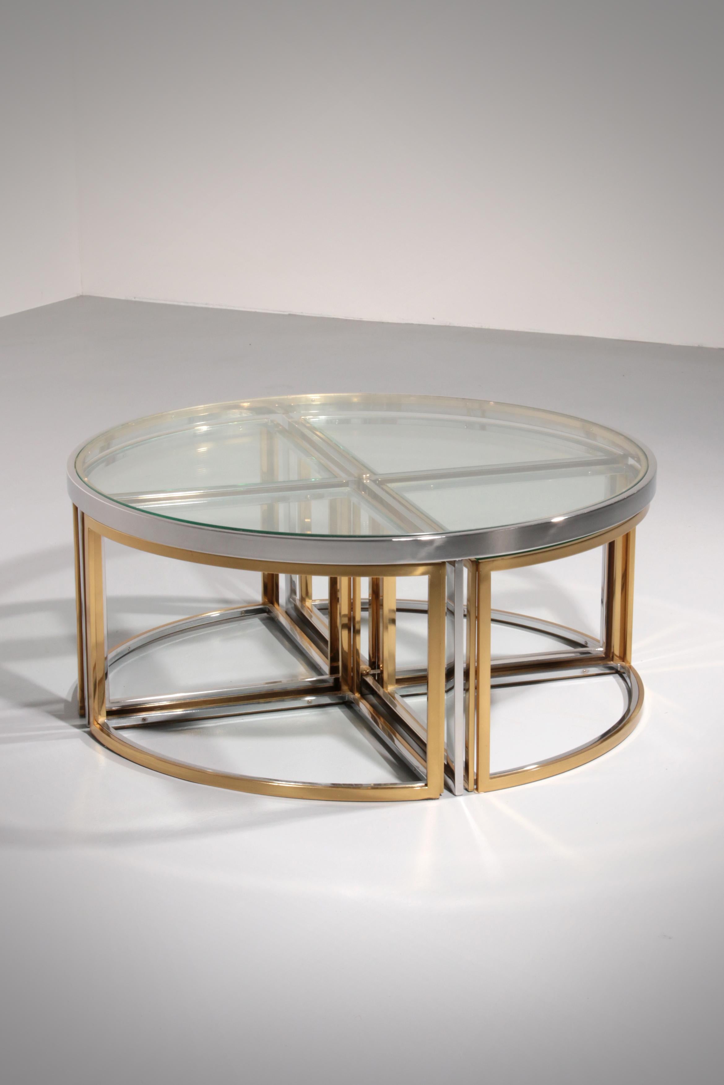 

Step into the refined world of 1970s French design with this stunning coffee table set by Maison Charles. Known for their luxurious and elegant creations, Maison Charles masterfully combined brass, chrome, and glass to create a piece that feels
