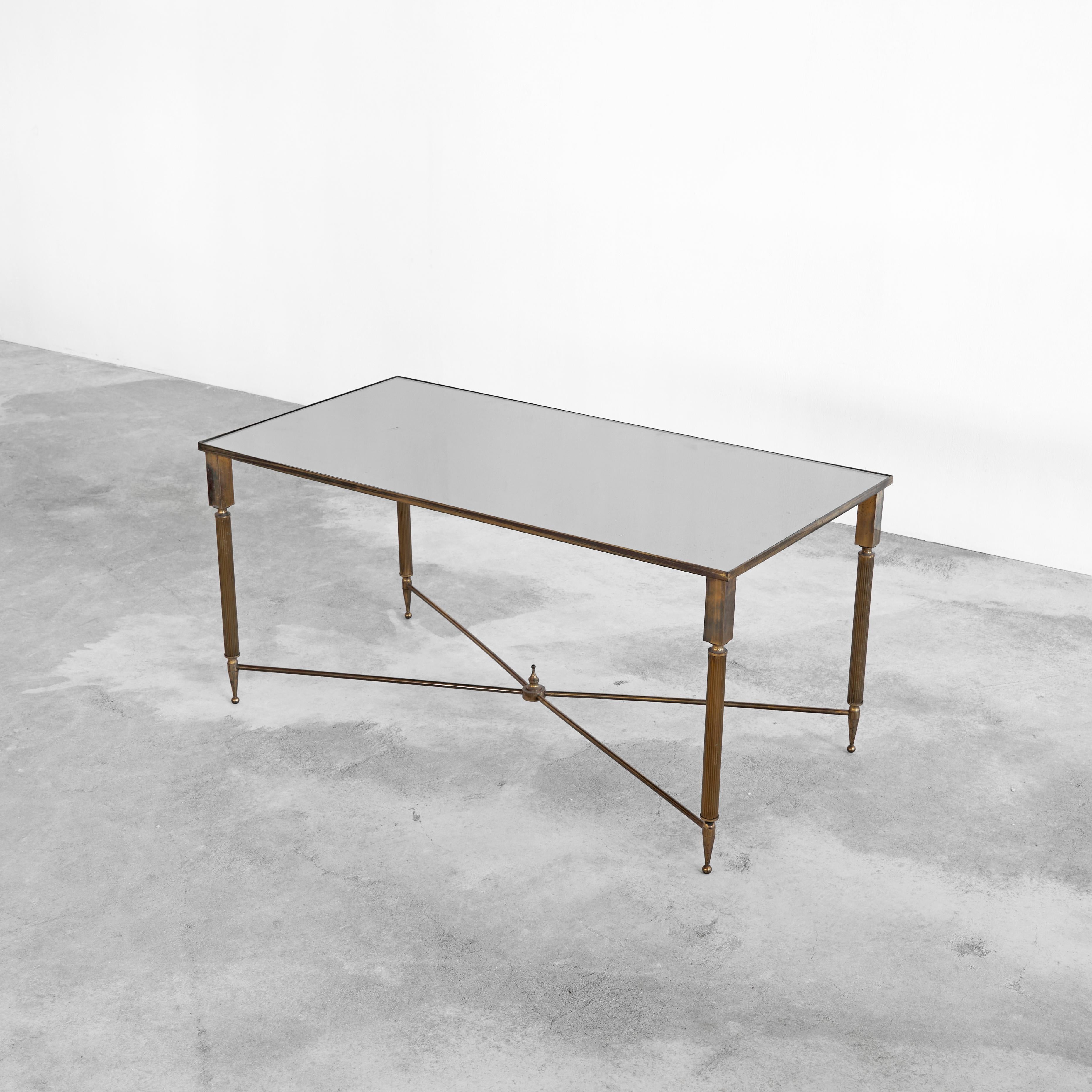 Maison Charles Coffee Table in Patinated Brass and Mirror Glass, France, 1960s.

Beautiful coffee table in patinated brass and mirror glass. Wonderful contrast between the slender thin brass legs and edges and the bulky elements at the top of the