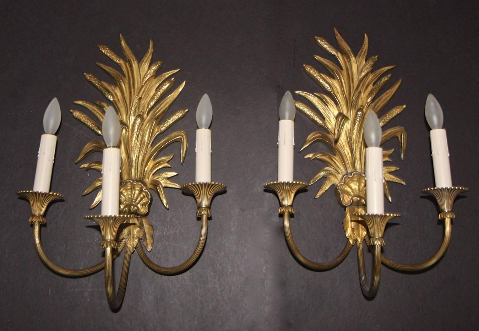 Fabulous pair of gilt bronze three-arm wall sconces, finely detailed wheat sheath and shell motif by Maison Charles. Style 