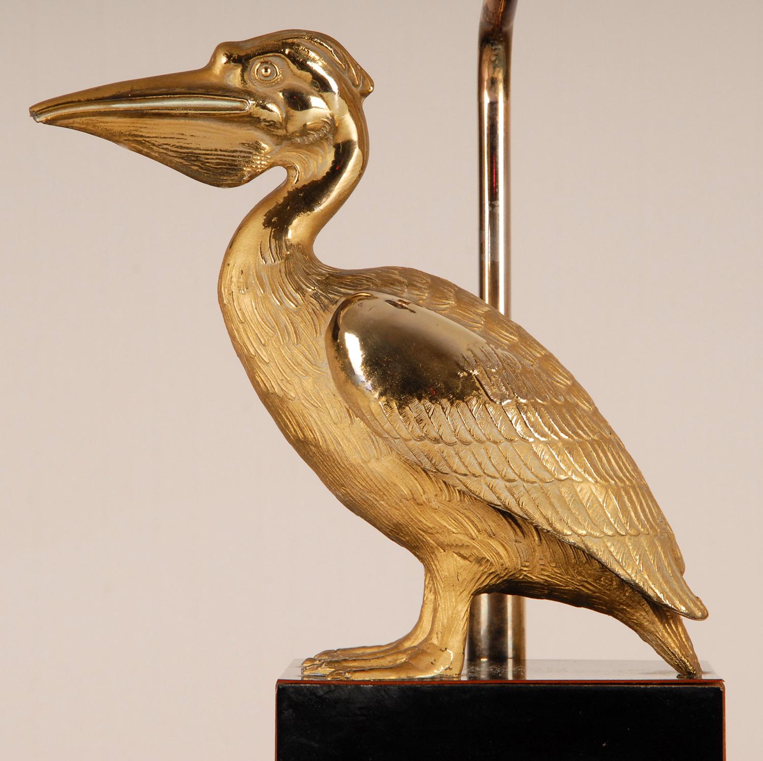 Maison Charles style table lamp
Elegant figural table lamp 
Depicting a gilt brass Pelican Bird on a black stepped base.
The Beige / Champagne colored lampshade is made of silk trimmed with gold.
The lamp is black corded and contains a on - off