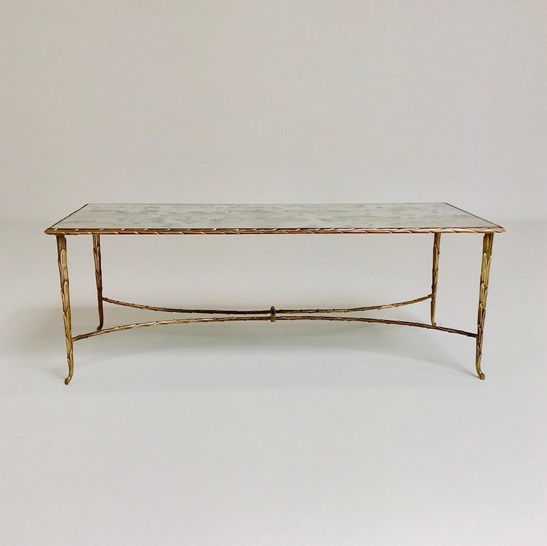 Beautiful gilt bronze coffee table by Maison Charles, circa 1950, France.
Palm trunk motif frame and oxidized mirror.
Nice quality and good condition.
All purchases are covered by our Buyer Protection Guarantee.
This item can be returned within 7