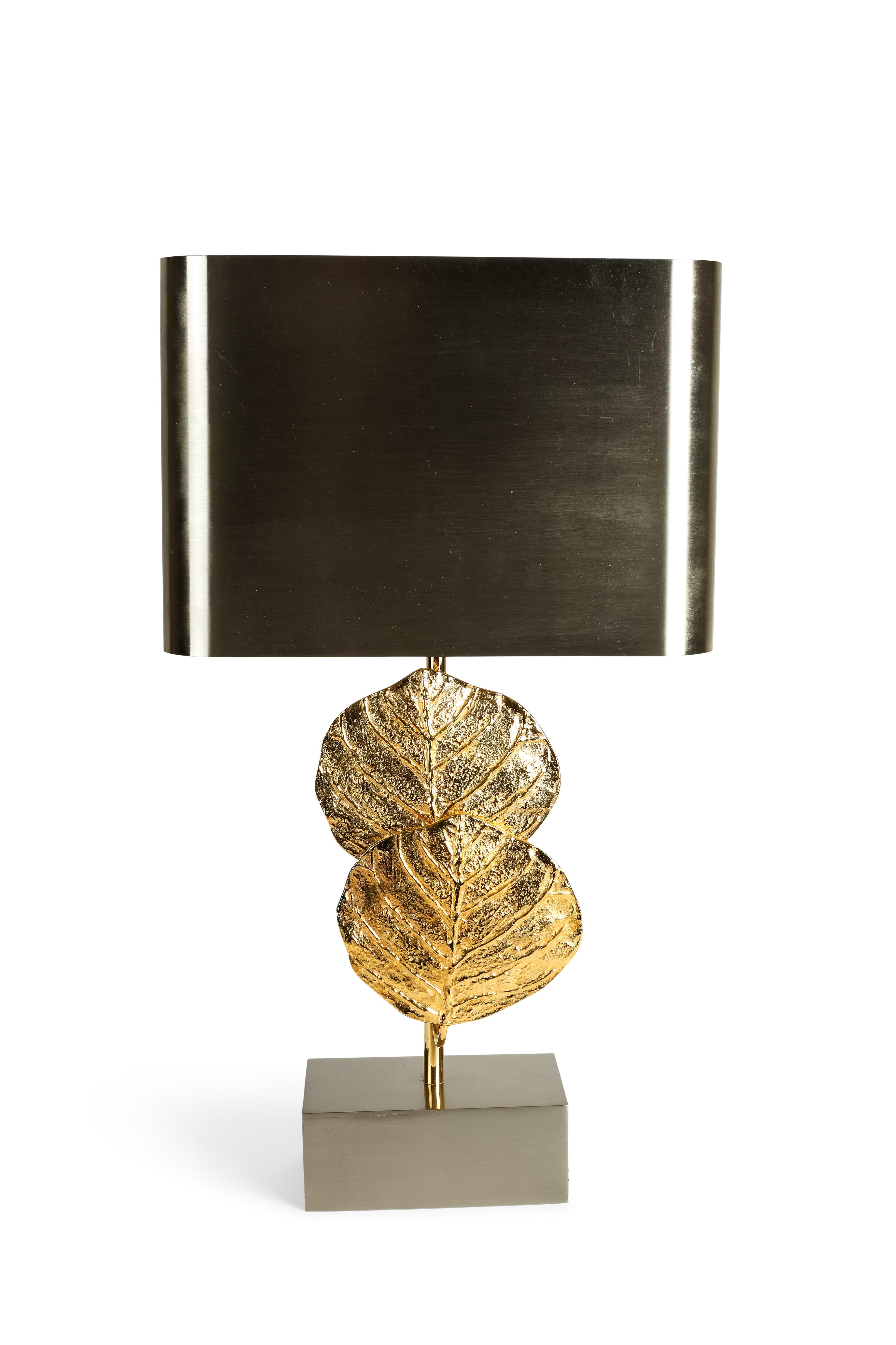 These lamps were designed by Christiane Charles for Maison Charles in 1970. There are documented in their catalogue. The bases and the shades have a silver patina while the central 2 leaves are in gilded bronze. American wired and signed. They have