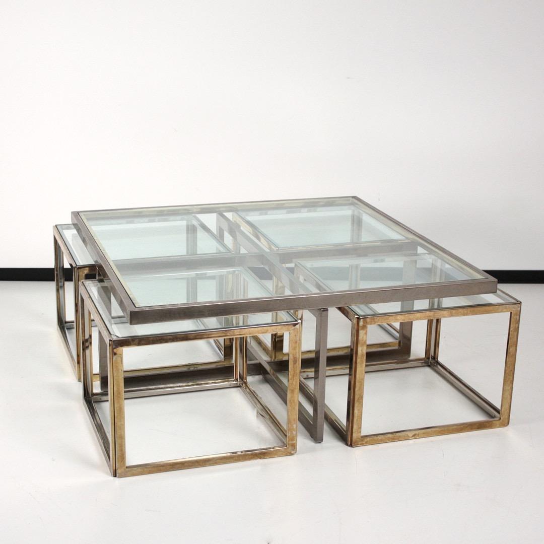 1970s Coffee table with four side tables from Maison Charles, France. Construction made of zinc-plated, galvanized steel, chrome-plated and gilded, loosely fitted clear glass plate and greenish-tinted panes. 

The four side tables can be fitted