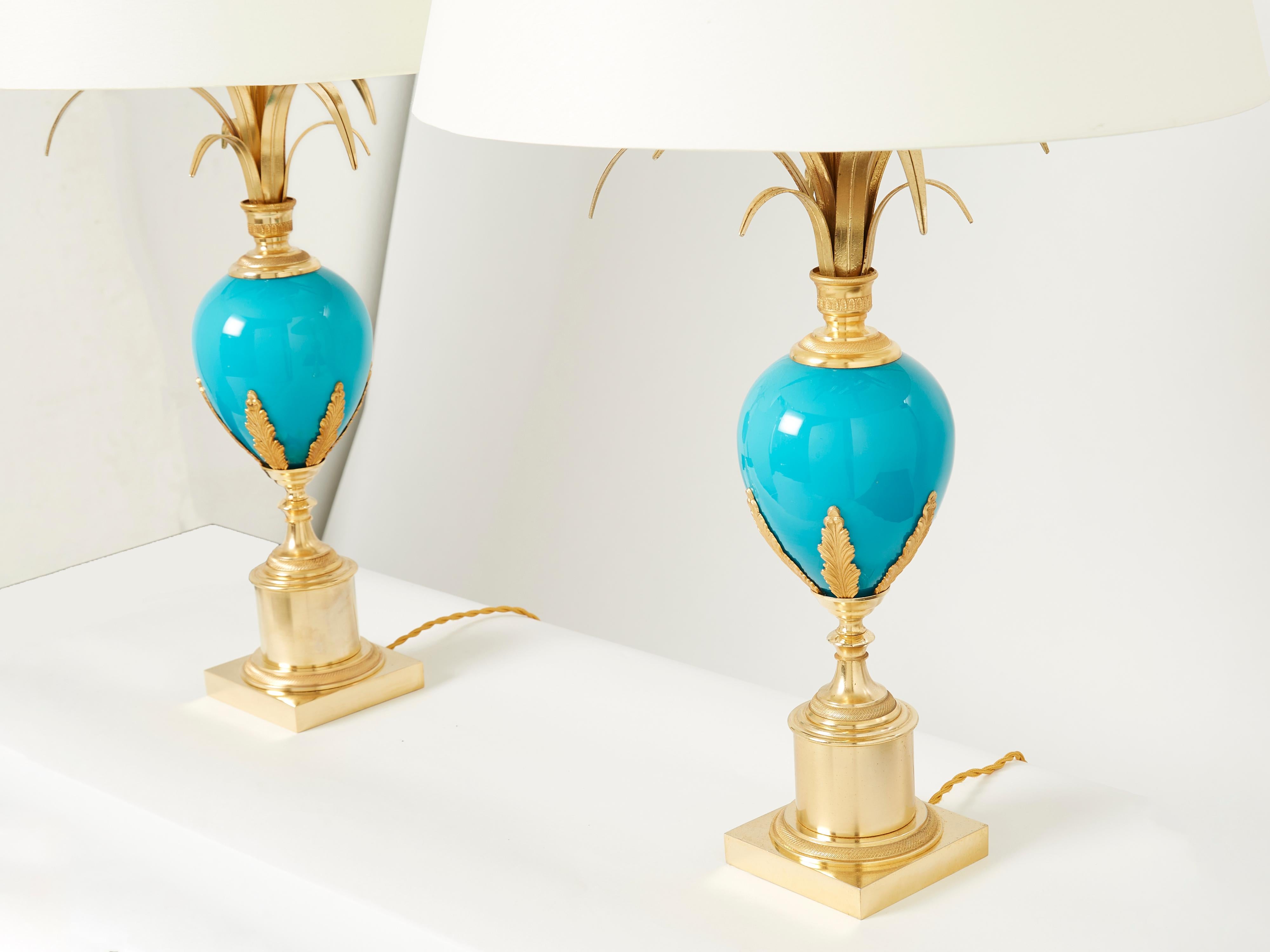 Vintage Maison Charles table lamps use nature as a muse, and this beautiful pair of lamps is a perfect example. They feature a beautiful brass base combined with a striking blue opaline ostrich egg in its center. Topped with made on order off-white