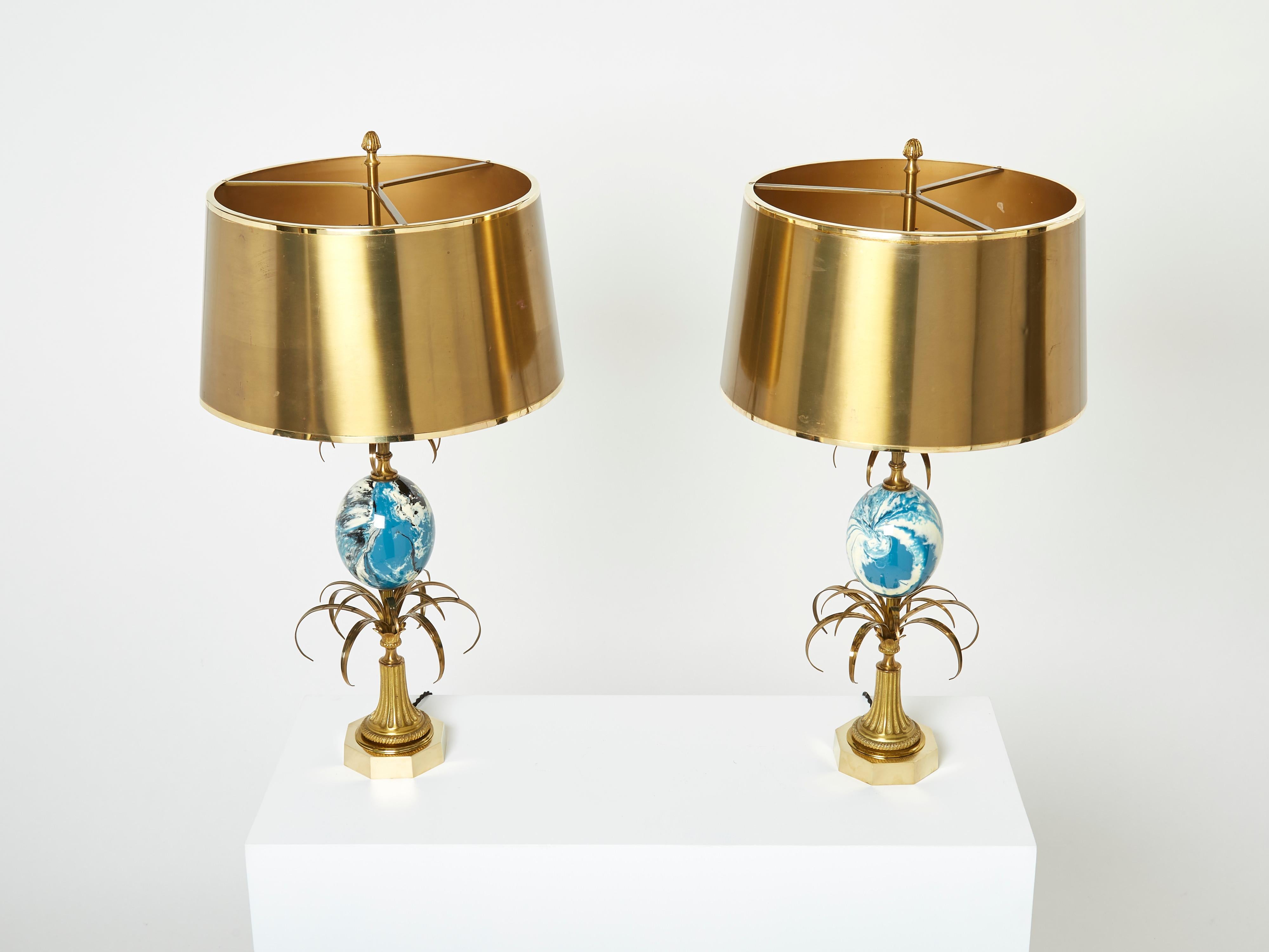 Vintage Maison Charles table lamps use nature as a muse, and this beautiful pair of lamps is a perfect example. They feature a beautiful brass base combined with a striking blue and white bakelite and resine ostrich egg in its center. They are