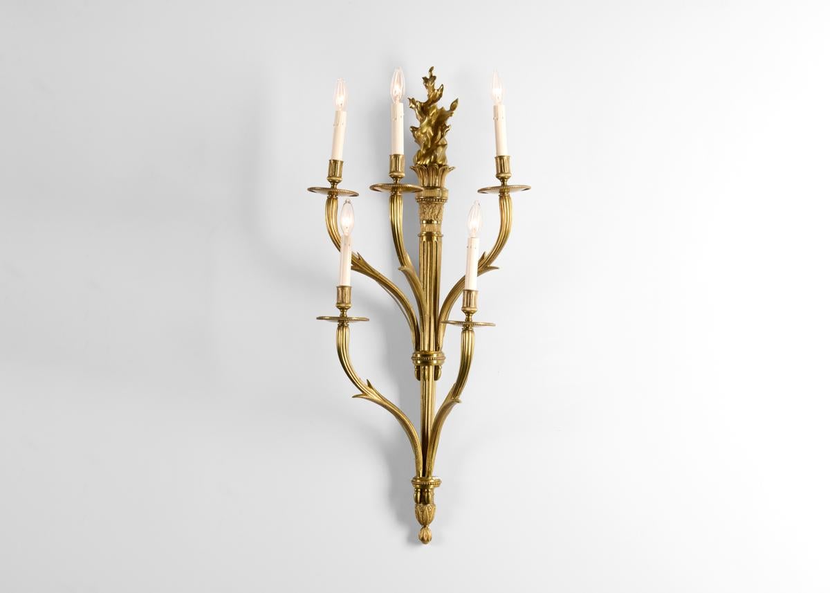 Signed: Charles & Fils.

From the small committee room on the 1st floor of the Palais des Consuls in Rouen, these remarkable sconces possess five arms each rising like gilded serpents from their columnar center. Each is crowned with a sculptural