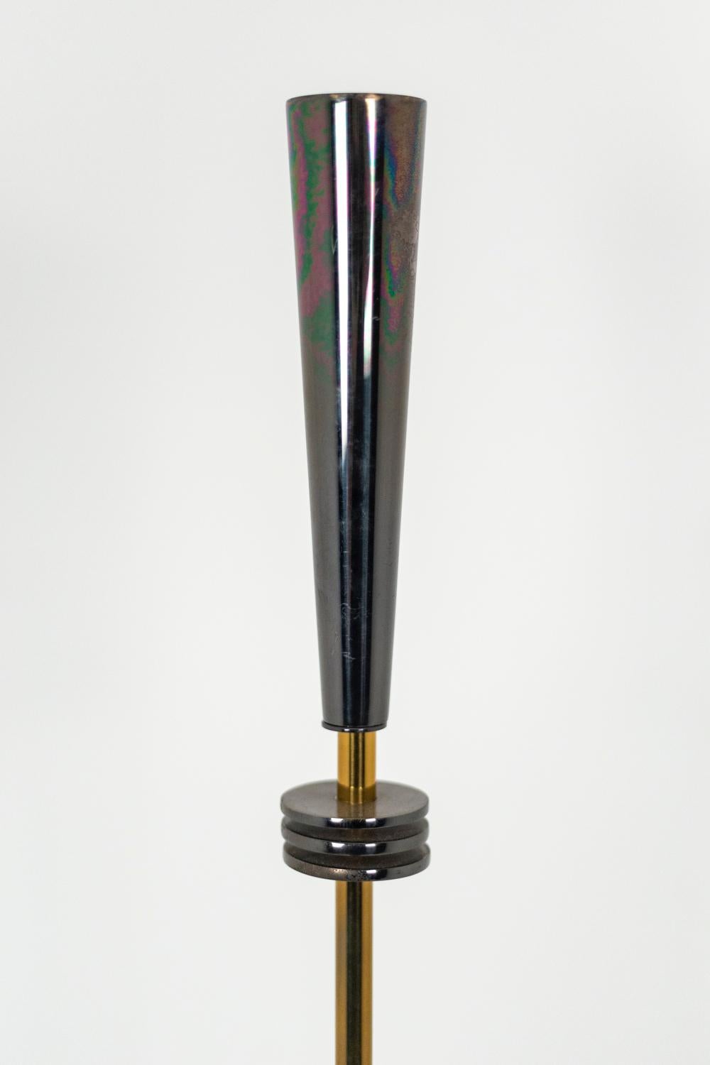 Maison Charles, attributed to.
“Quasar” floor lamp in metal. Iridescent conical lampshade above three parallel disks on the gilt leg. Circular base on two levels.

Work realized in the 20th century.

Work referenced 2268-0 in the Maison Charles