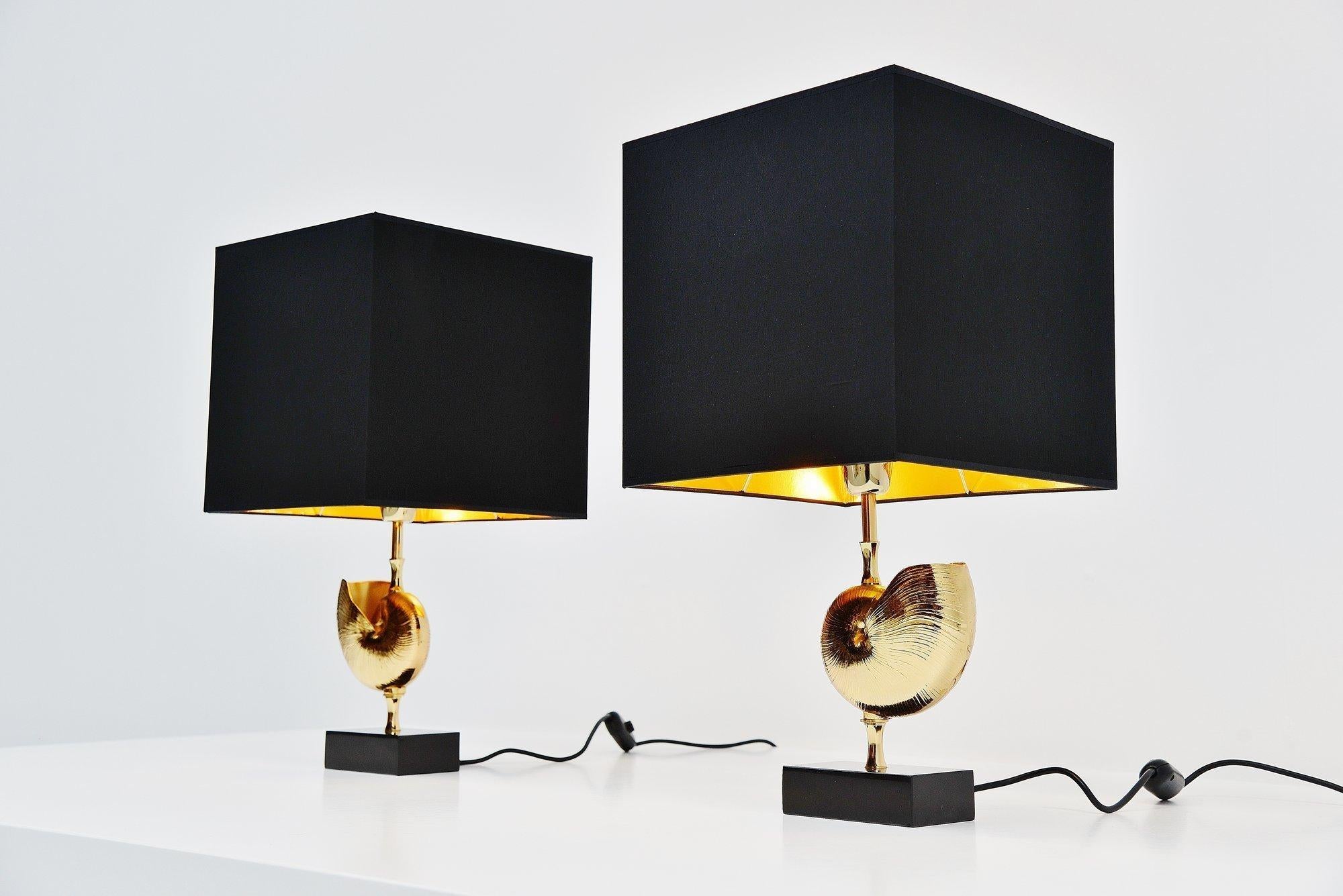 Very nice pair of shell shaped table lamps designed and manufactured by Maison Charles, France 1970. These table lamps have a solid black stone base and a brass shell shaped center. The lamps have a new made shades in black and with a golden inside.