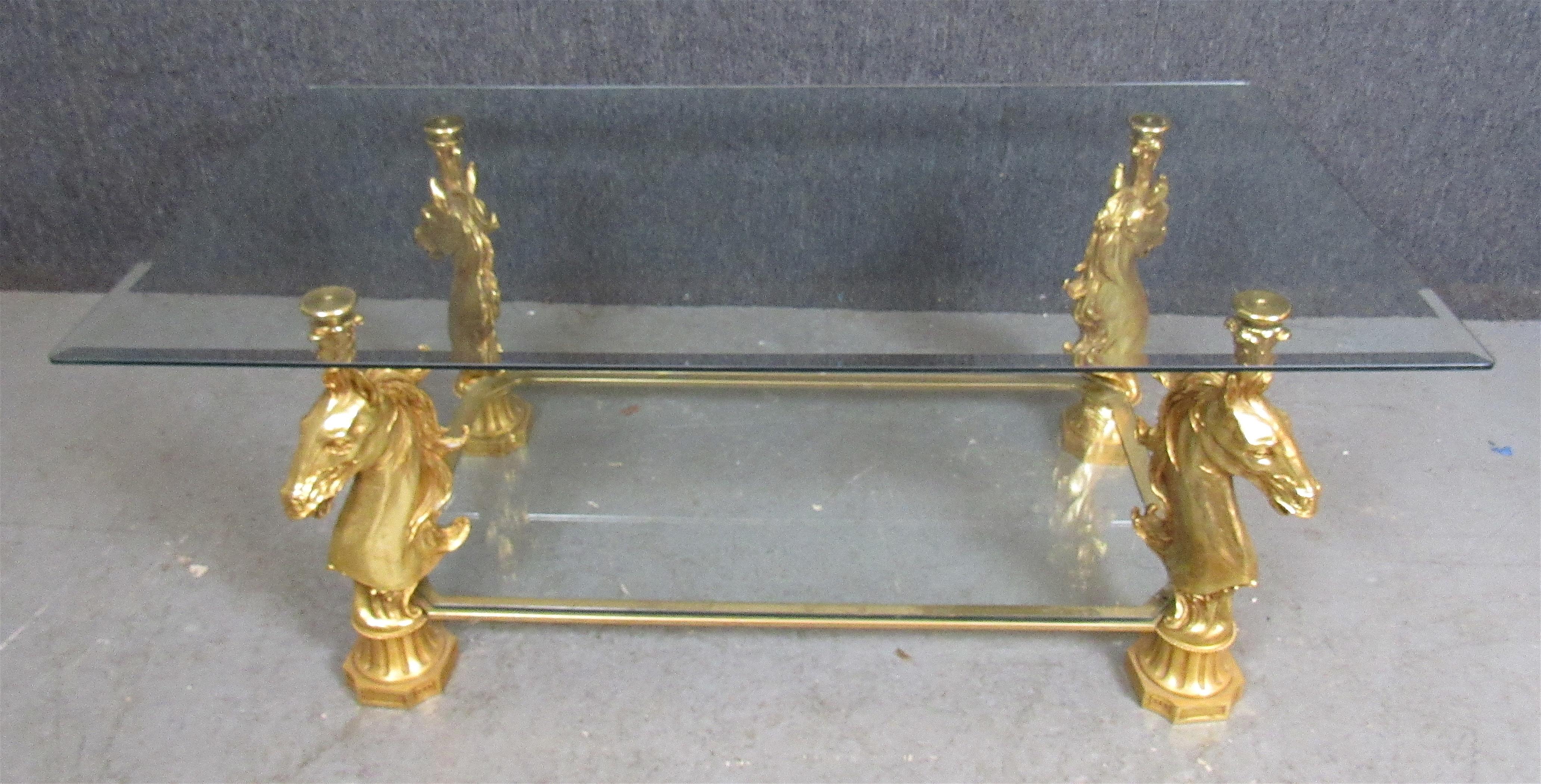 Unique two level glass table with finely detailed horse head supports. Signed 